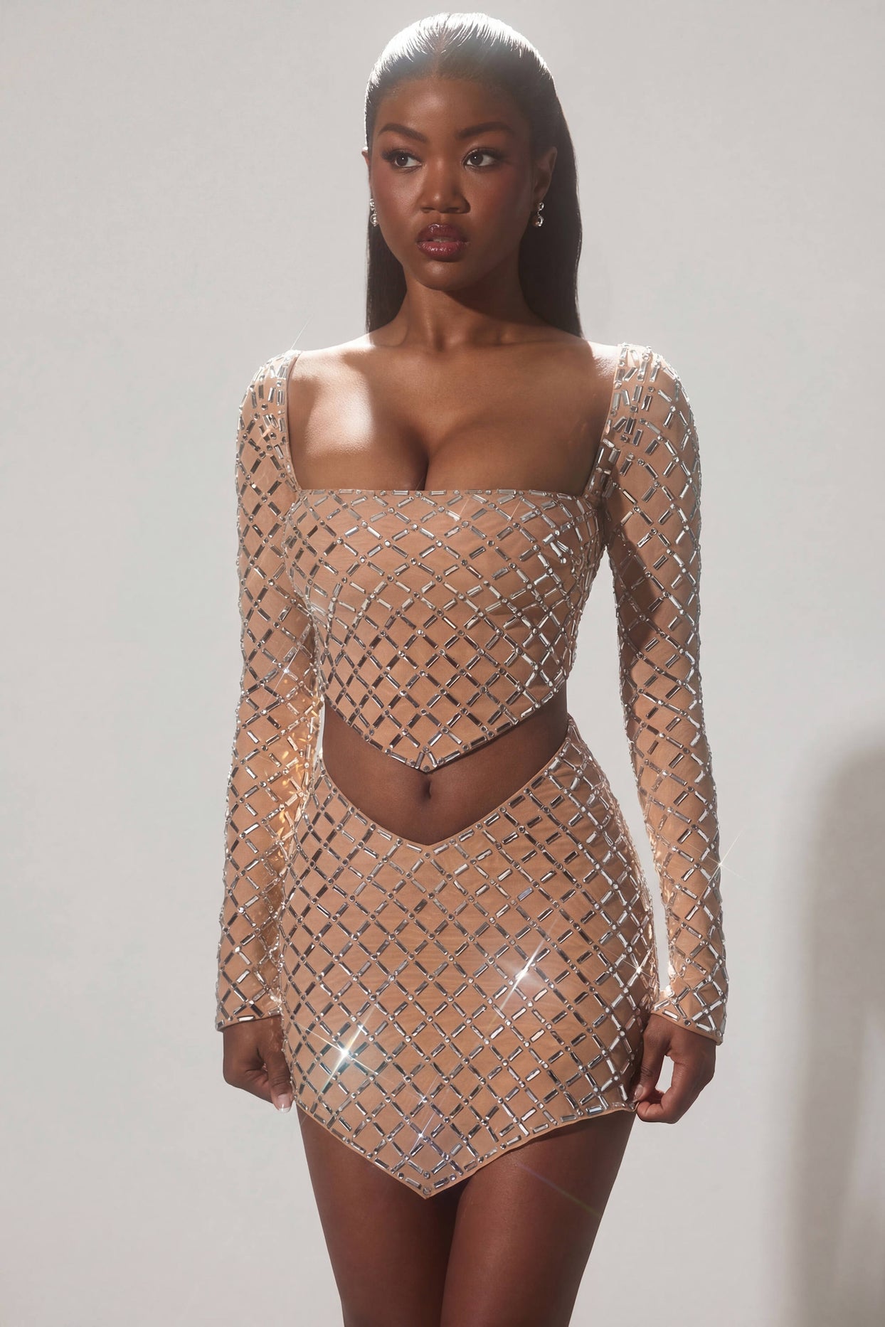 Oh Polly's Sevah wearing the Veah Mini Skirt in Almond Square Hotfix fabric perfect for clubbing with friends