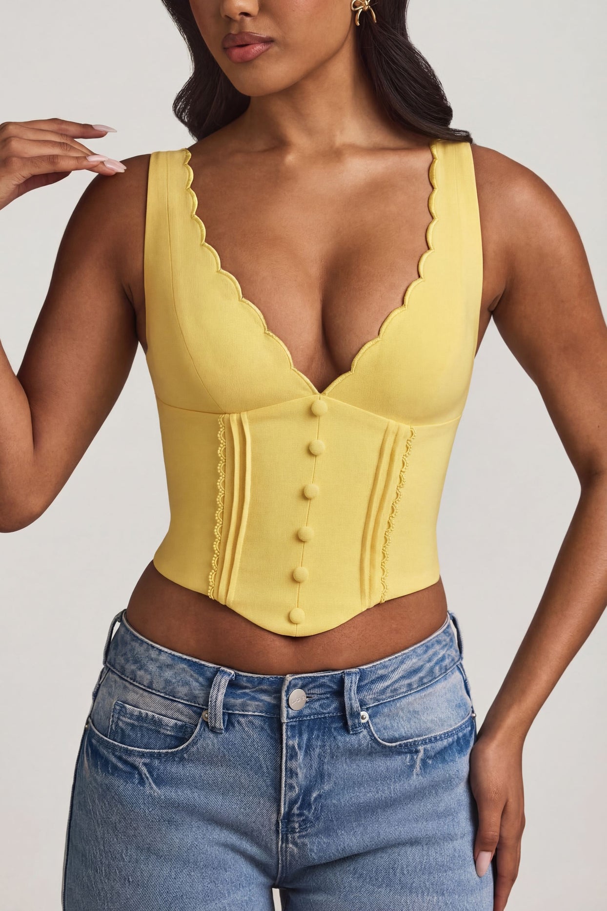 Oh Polly's Yarelis wearing the Lucia Corset Top in Pastel Yellow Stretch Woven fabric perfect for daytime dates