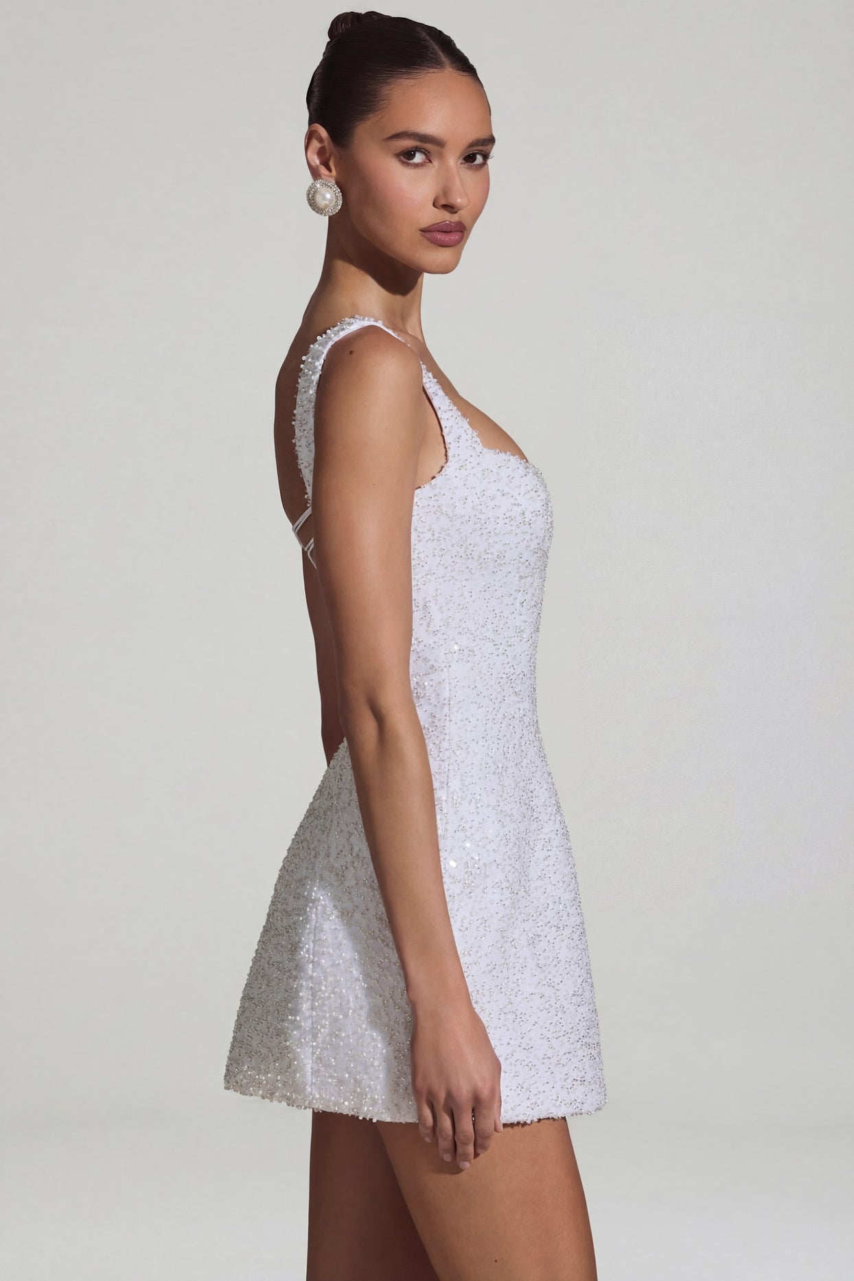Oh Polly's Anna wearing the Dominique Mini Dress in White Embellished fabric perfect for bridal showers