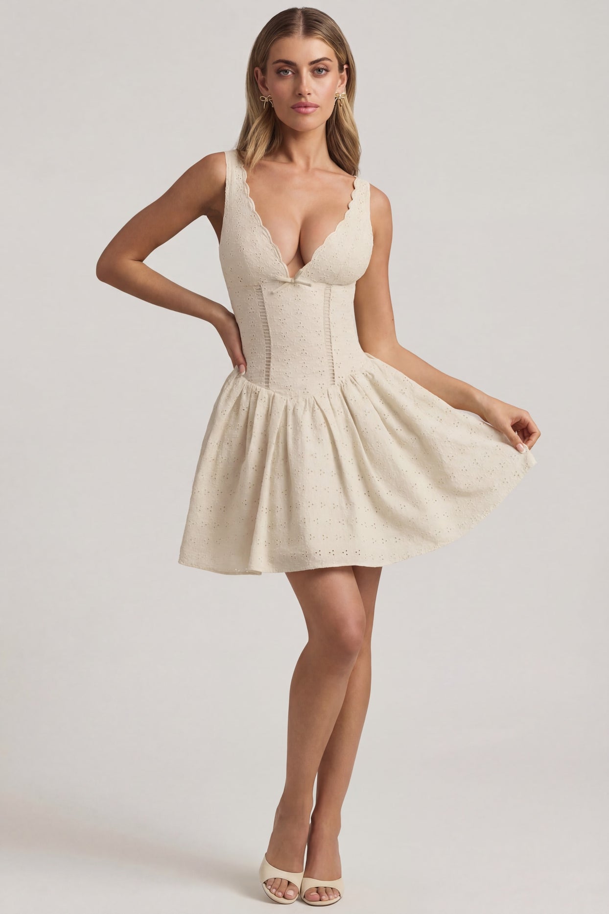 Oh Polly's Freya Tidy wearing the Sabina Mini Dress in Ivory Woven fabric perfect for elegant evening dinners