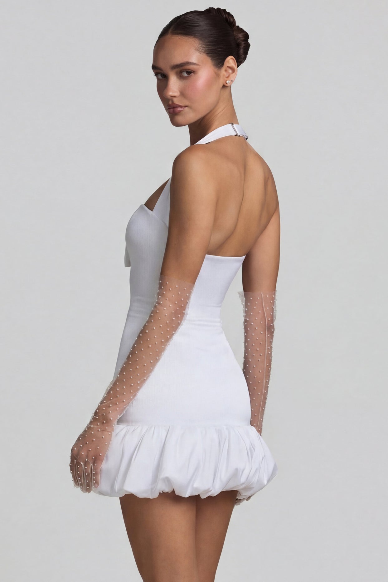 Oh Polly's Anna wearing the Millie Mini Dress in White Recycled Satin fabric perfect for rooftop brunches