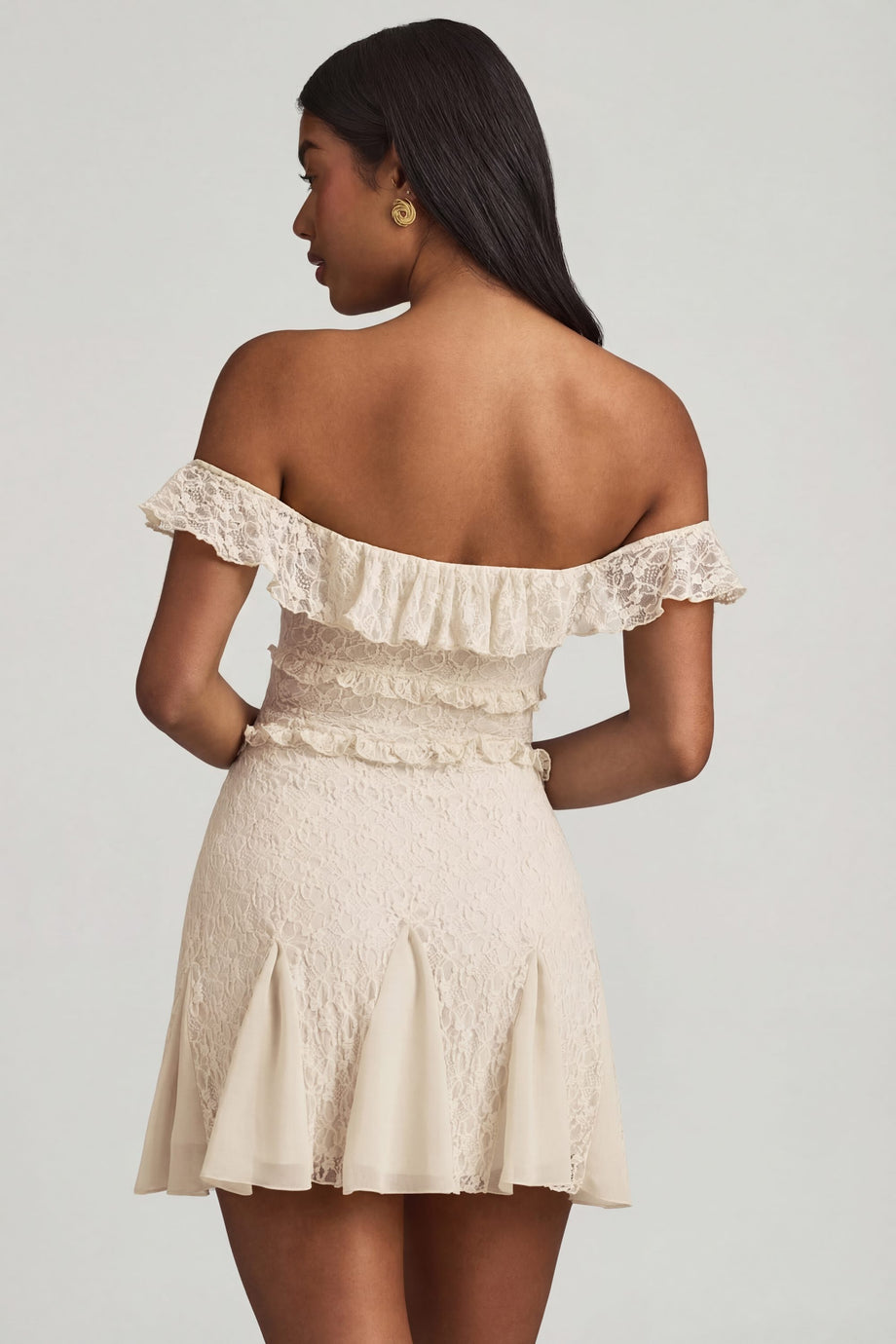 Oh Polly's Yarelis wearing the Nahida Mini Dress in Ivory Stretch Lace fabric perfect for summer garden parties