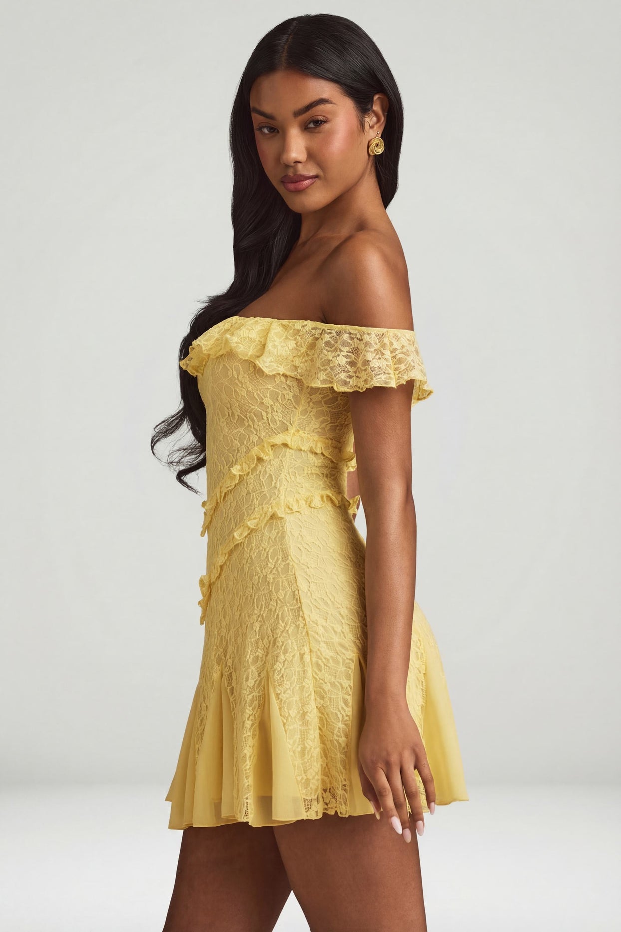 Oh Polly's Yarelis wearing the Nahida Mini Dress in Pastel Yellow Stretch Lace fabric perfect for brunch with friends