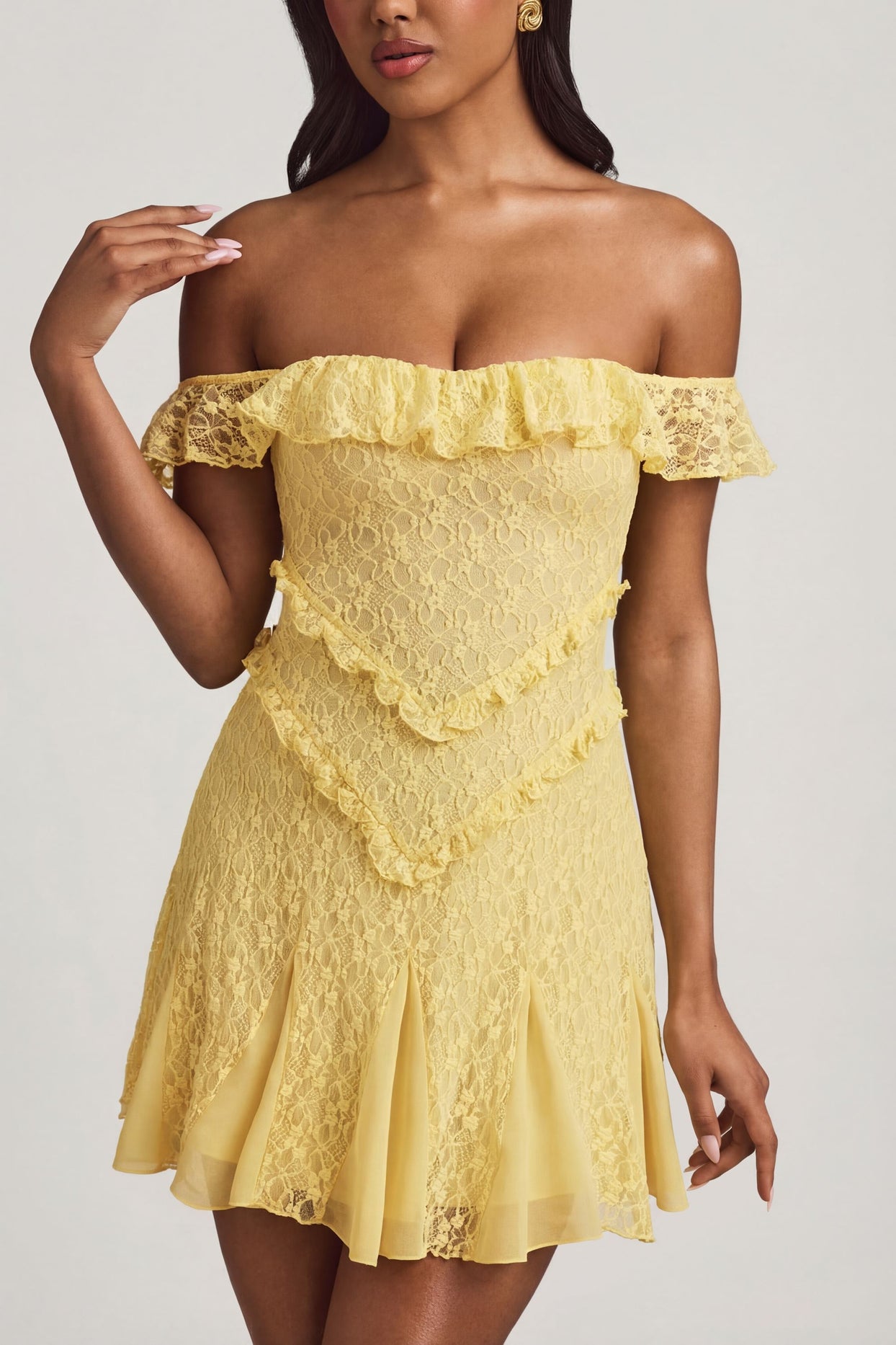 Oh Polly's Yarelis wearing the Nahida Mini Dress in Pastel Yellow Stretch Lace fabric perfect for spring date nights