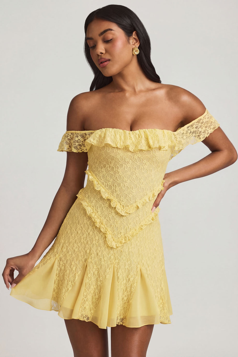 Oh Polly's Yarelis wearing the Nahida Mini Dress in Pastel Yellow Stretch Lace fabric perfect for bridal showers