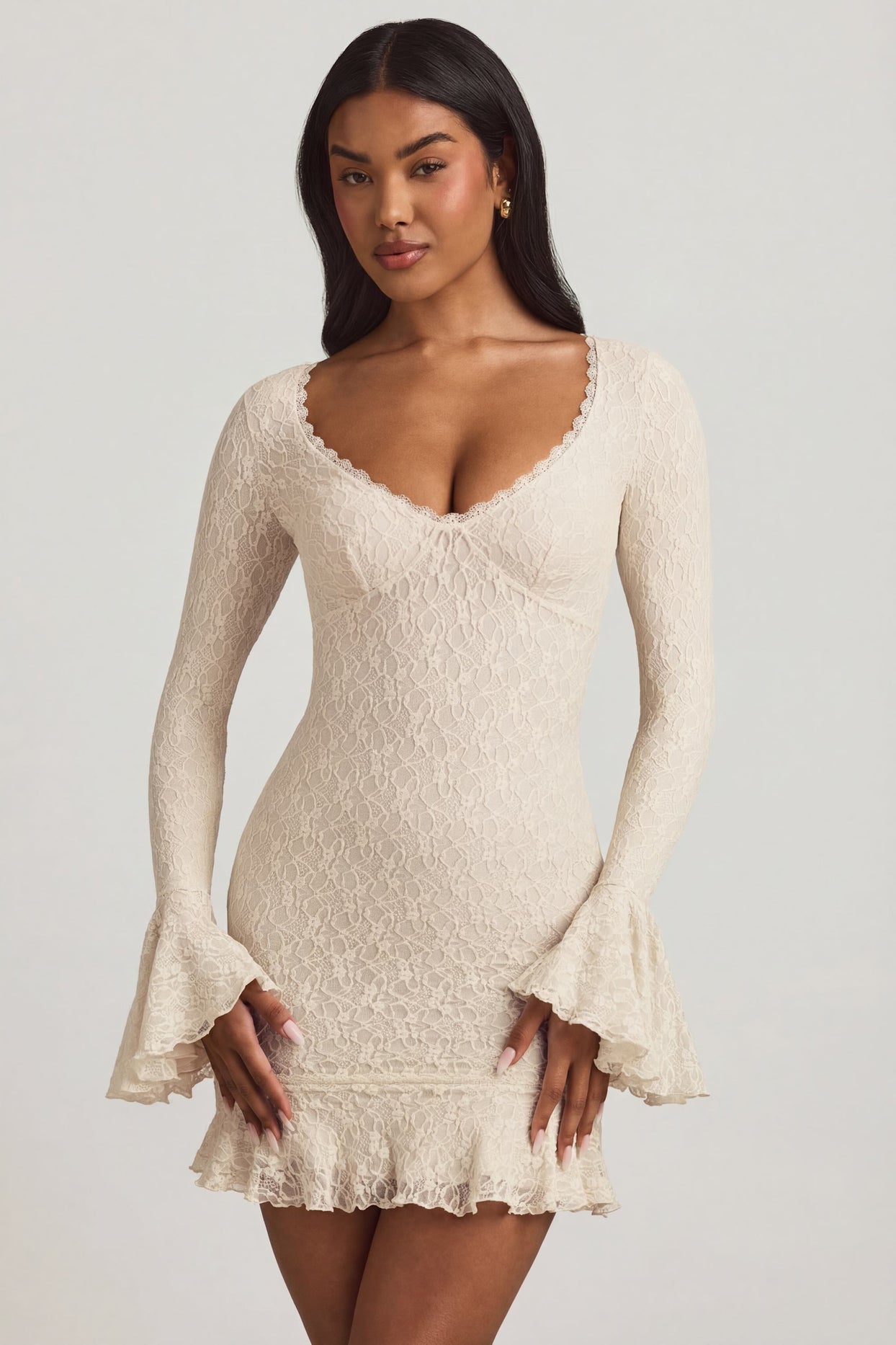 Oh Polly's Yarelis wearing the Nara Mini Dress in Ivory Stretch Lace fabric perfect for summer garden parties