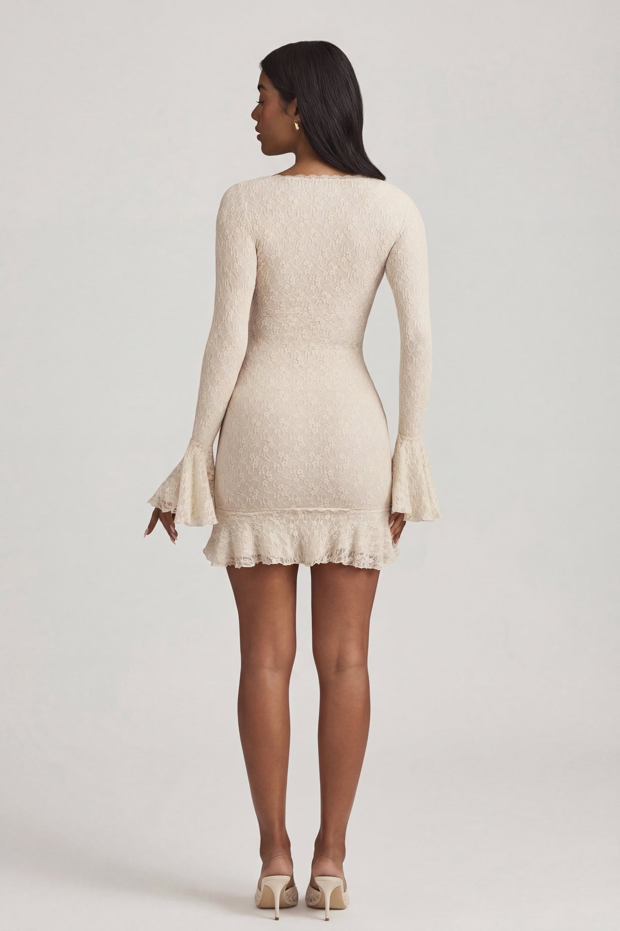 Oh Polly's Yarelis wearing the Nara Mini Dress in Ivory Stretch Lace fabric perfect for summer garden parties