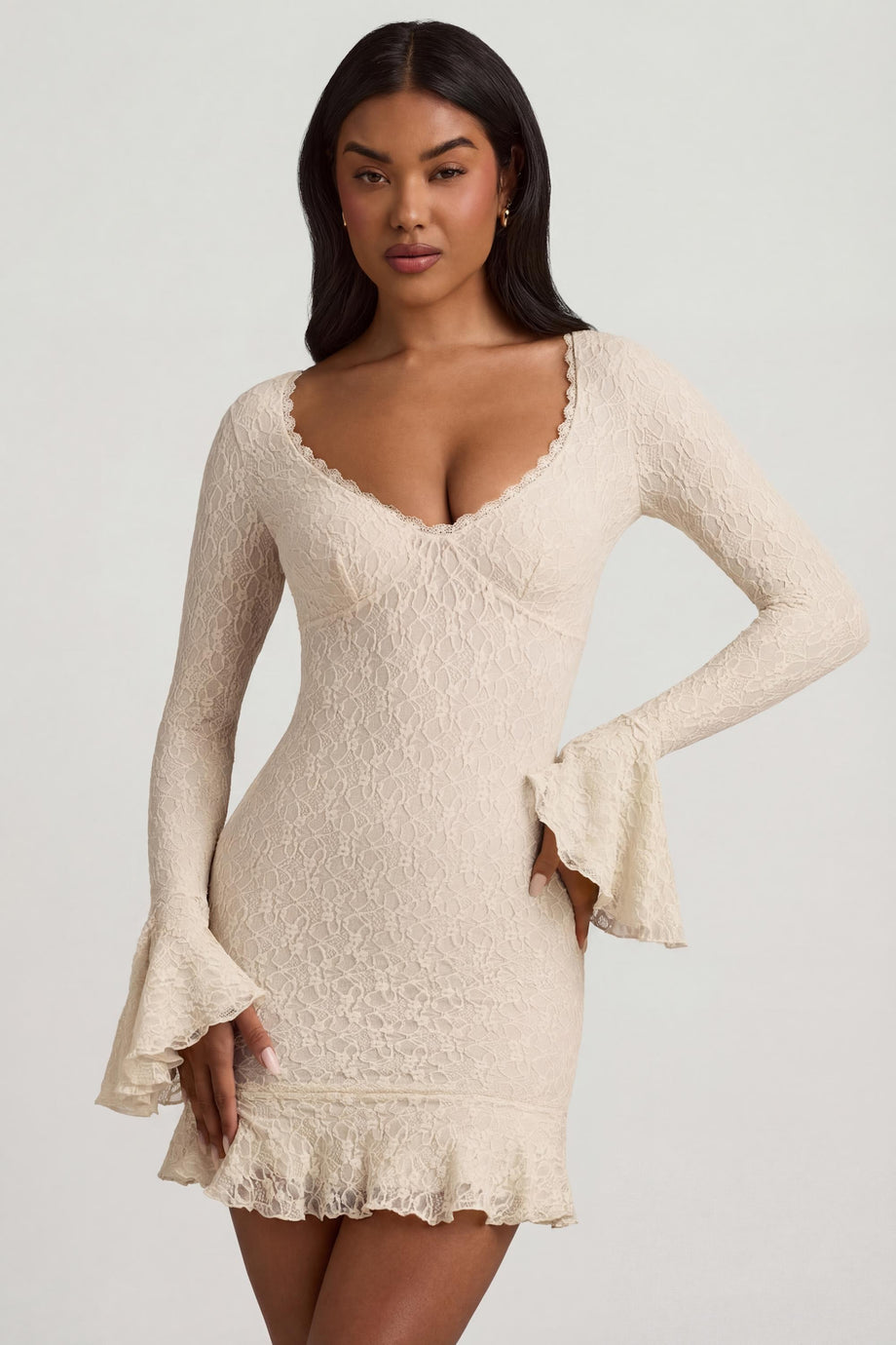 Oh Polly's Yarelis wearing the Nara Mini Dress in Ivory Stretch Lace fabric perfect for elegant dinner outings