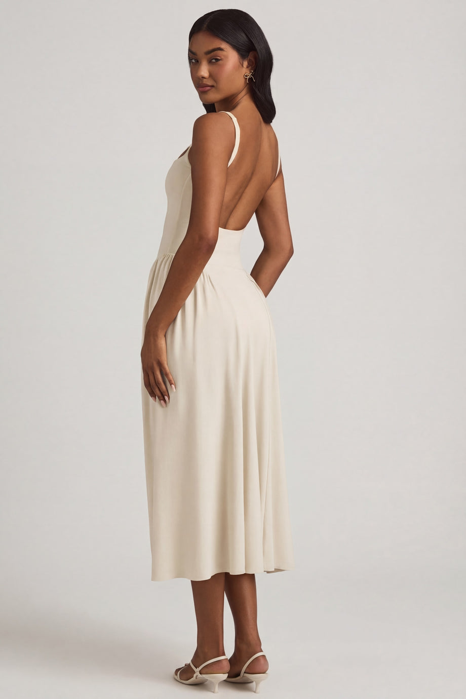 Oh Polly's Yarelis wearing the Aireen Midaxi Dress in Ivory Modal fabric perfect for elegant evening events