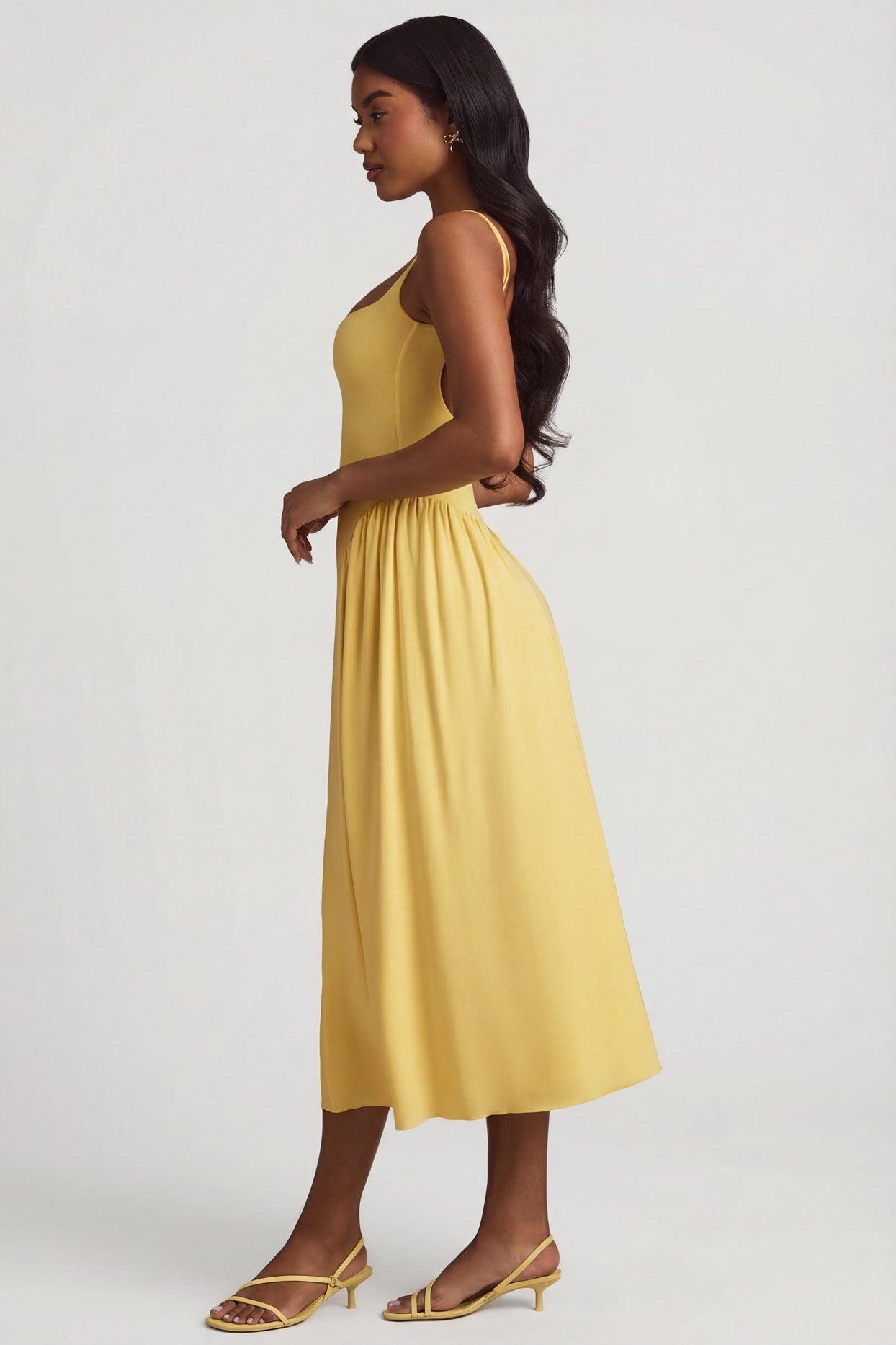Oh Polly's Yarelis wearing the Aireen Midaxi Dress in Pastel Yellow Modal fabric perfect for beachside dinners