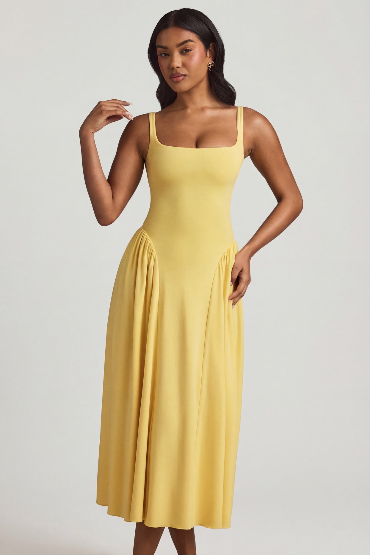 Oh Polly's Yarelis wearing the Aireen Midaxi Dress in Pastel Yellow Modal fabric perfect for beachside dinners