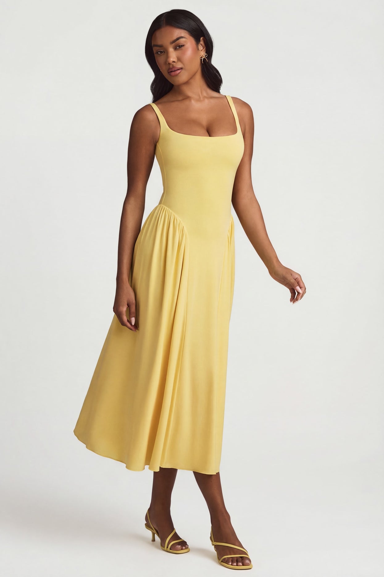 Oh Polly's Yarelis wearing the Aireen Midaxi Dress in Pastel Yellow Modal fabric perfect for spring weddings