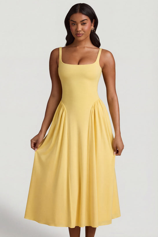 Oh Polly's Yarelis wearing the Aireen Midaxi Dress in Pastel Yellow Modal fabric perfect for rooftop cocktails