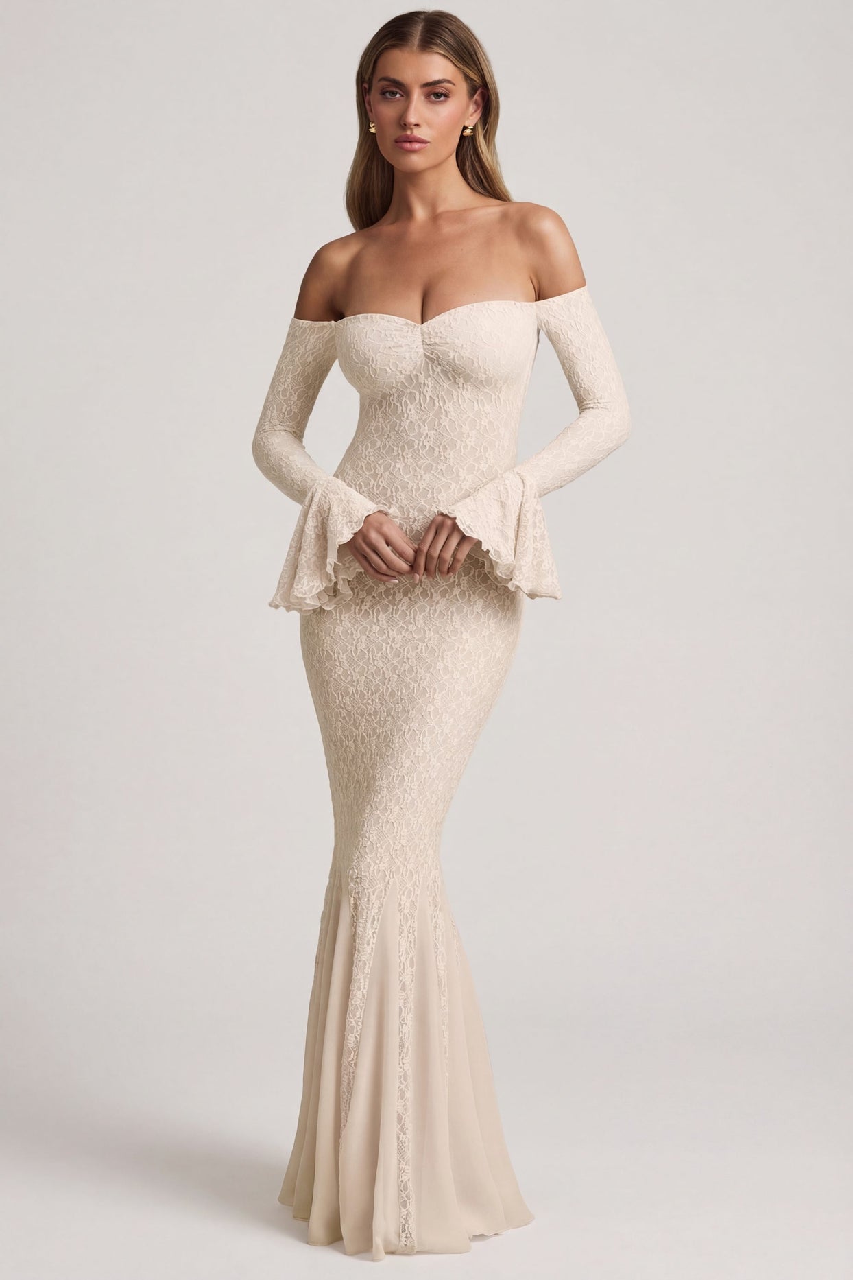 Oh Polly's Freya Tidy wearing the Verena Maxi Dress in Ivory Stretch Lace fabric perfect for beachside dinners