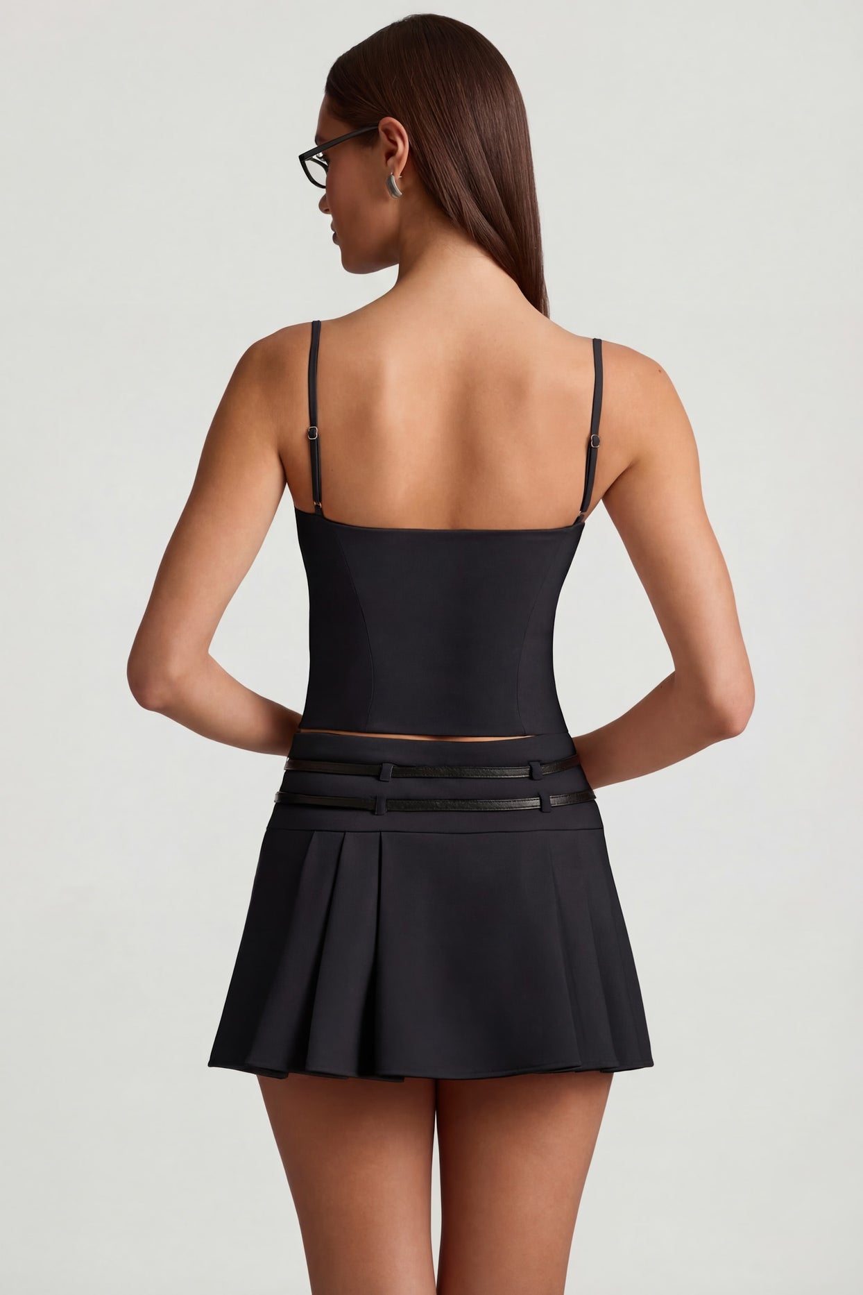 Oh Polly's Anna wearing the Velora Mini Skirt in Black fabric perfect for a night out