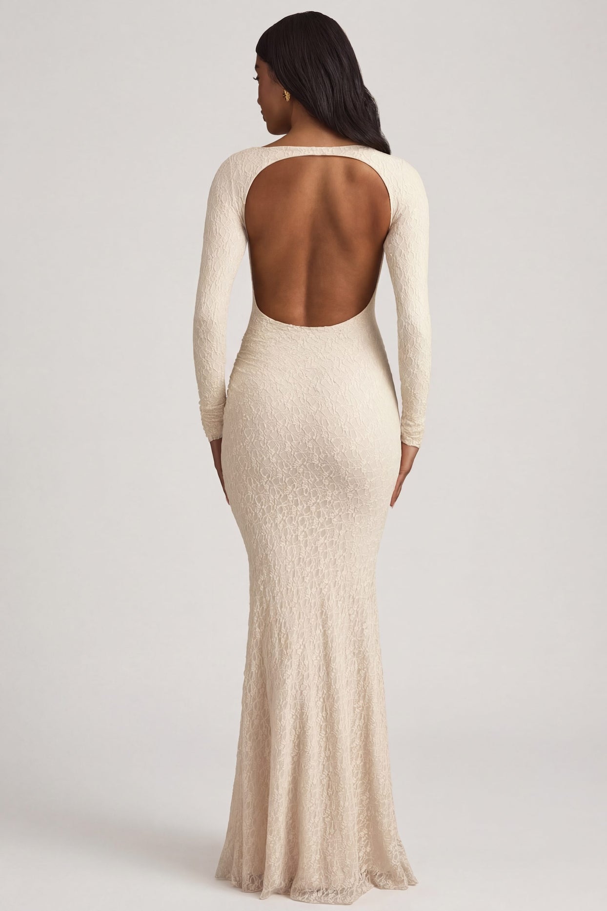 Oh Polly's Yarelis wearing the Tarini Maxi Dress in Ivory Stretch Lace fabric perfect for beachside weddings