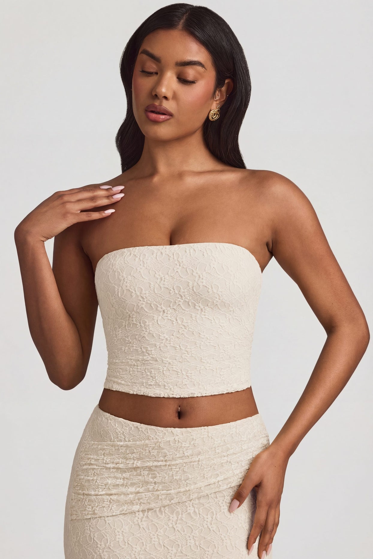 Oh Polly's Yarelis wearing the Tamia Full Top in Ivory Stretch Lace fabric perfect for summer garden parties