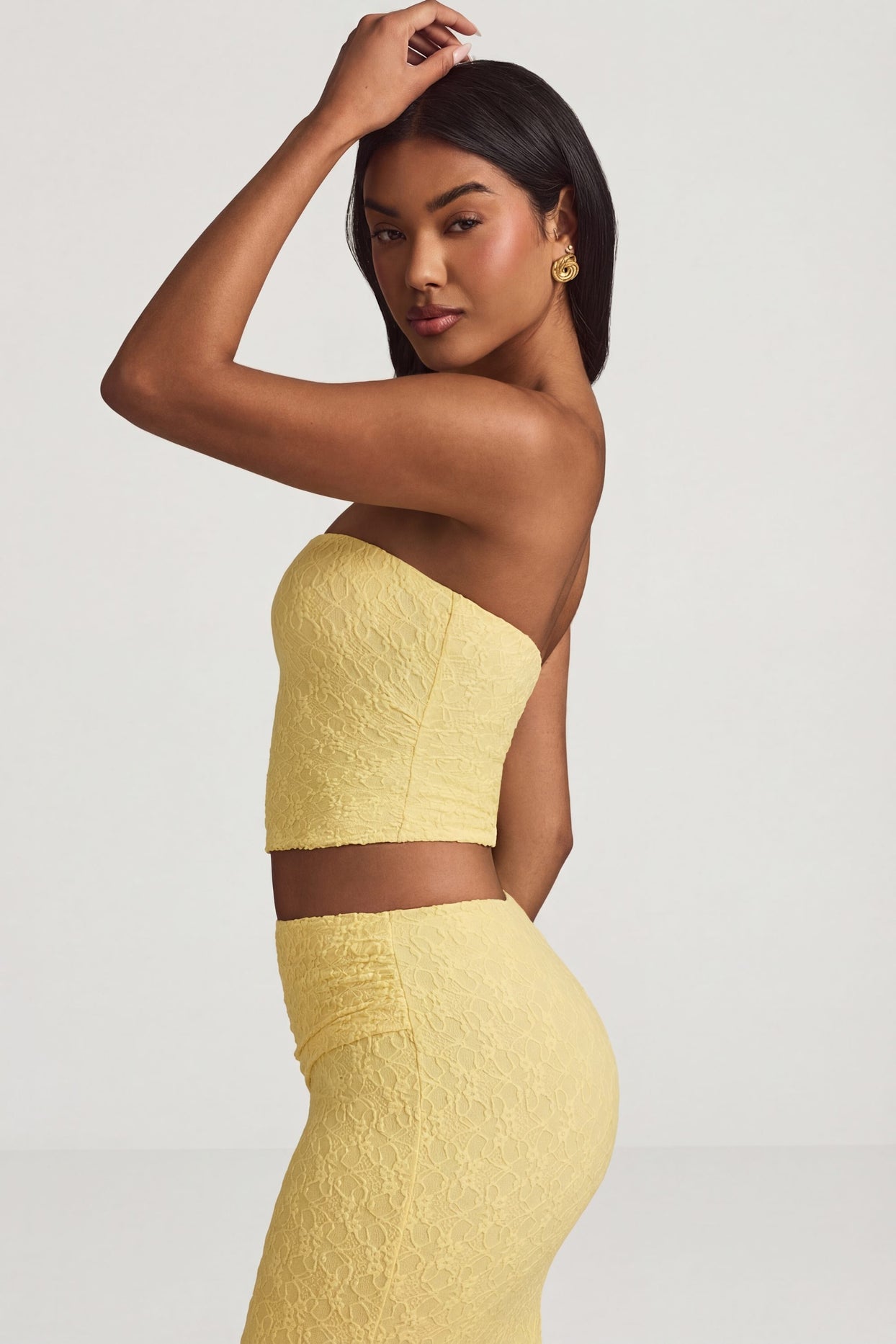Oh Polly's Yarelis wearing the Tamia Full Top in Pastel Yellow Stretch Lace fabric perfect for garden parties