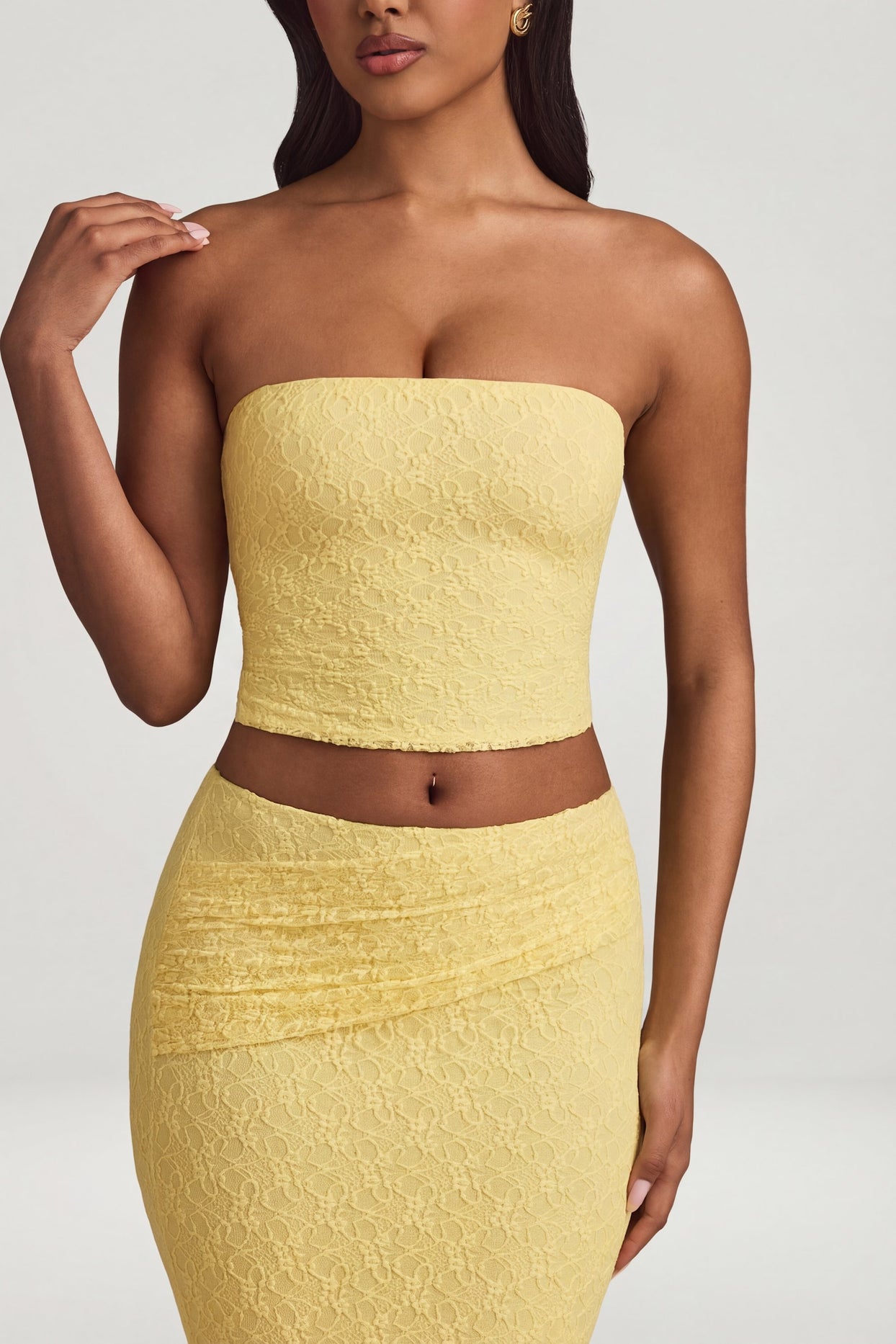 Oh Polly's Yarelis wearing the Tamia Full Top in Pastel Yellow Stretch Lace fabric perfect for garden parties