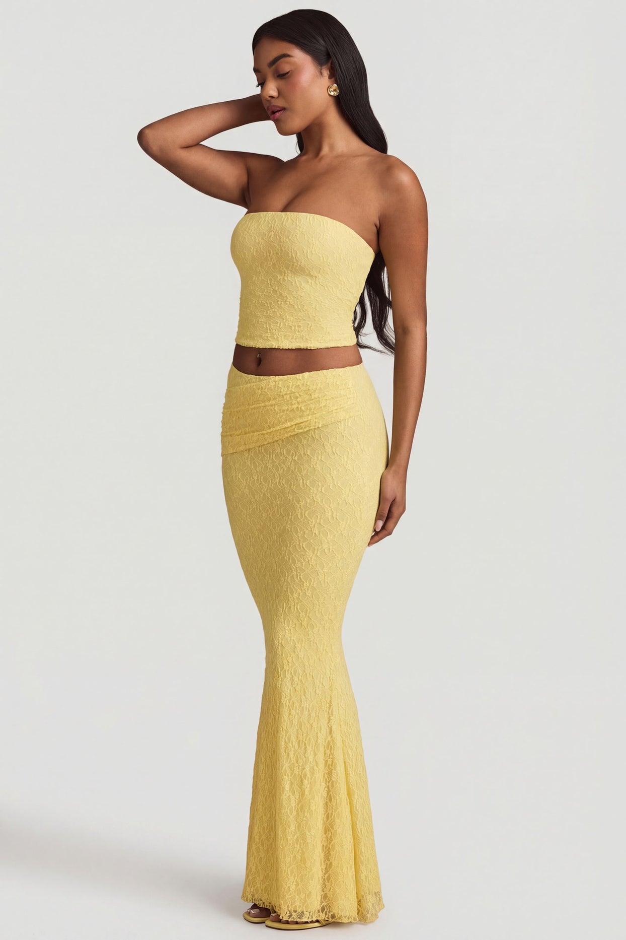 Oh Polly's Yarelis wearing the Tamia Full Top in Pastel Yellow Stretch Lace fabric perfect for beach vacations