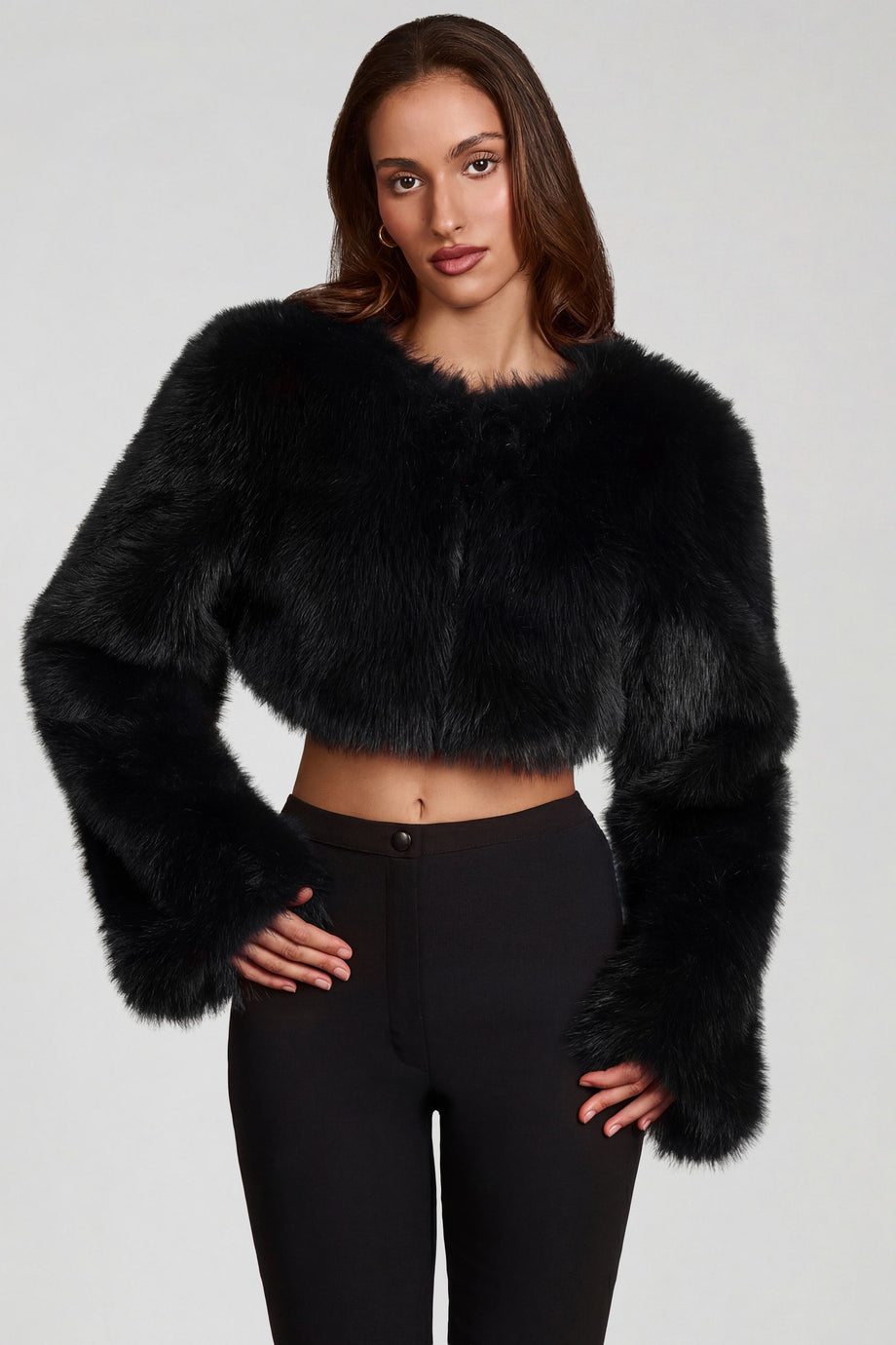 Oh Polly model Yasmin wearing the Almerinda Coat in Black Faux Fur fabric perfect for winter city strolls