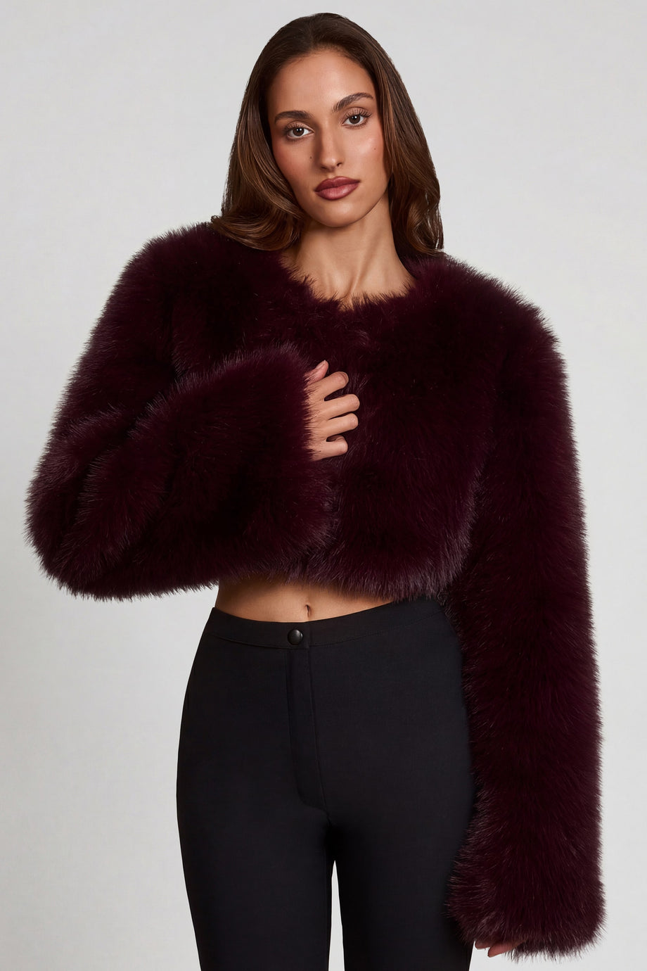 Oh Polly model Yasmin wearing the Almerinda Coat in Wine Faux Fur fabric perfect for winter date nights