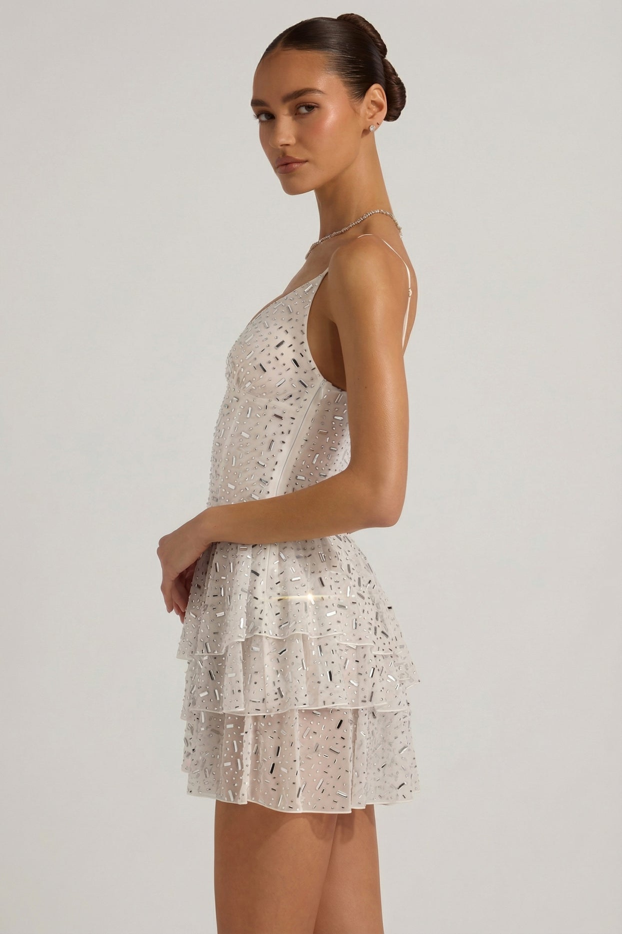 Oh Polly model Anna wearing the Orren Mini Dress in White Mesh fabric perfect for rooftop events