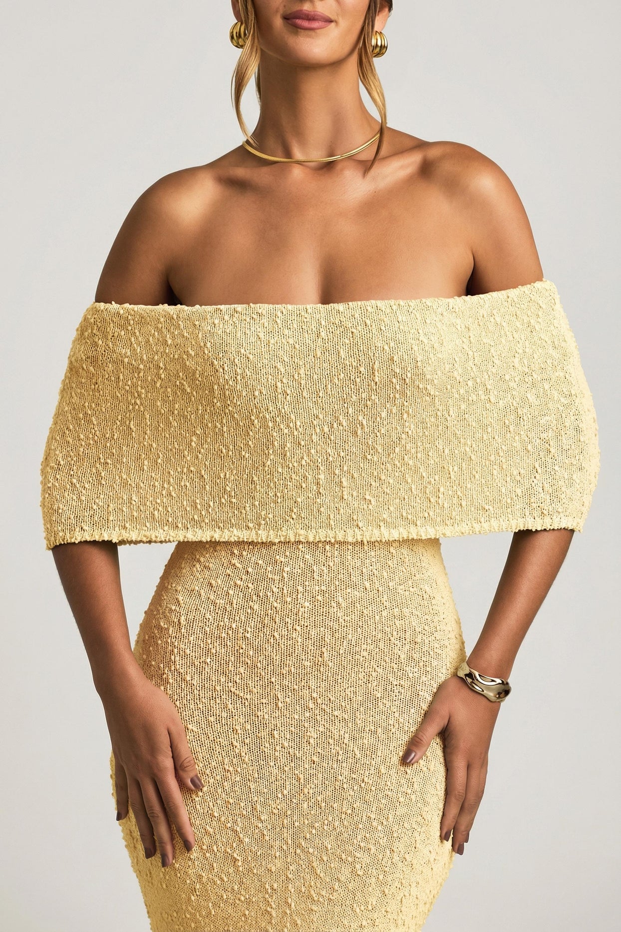 Oh Polly model Priscilla wearing the Naia Maxi Dress in Yellow Boucle Knit fabric perfect for vacation getaways