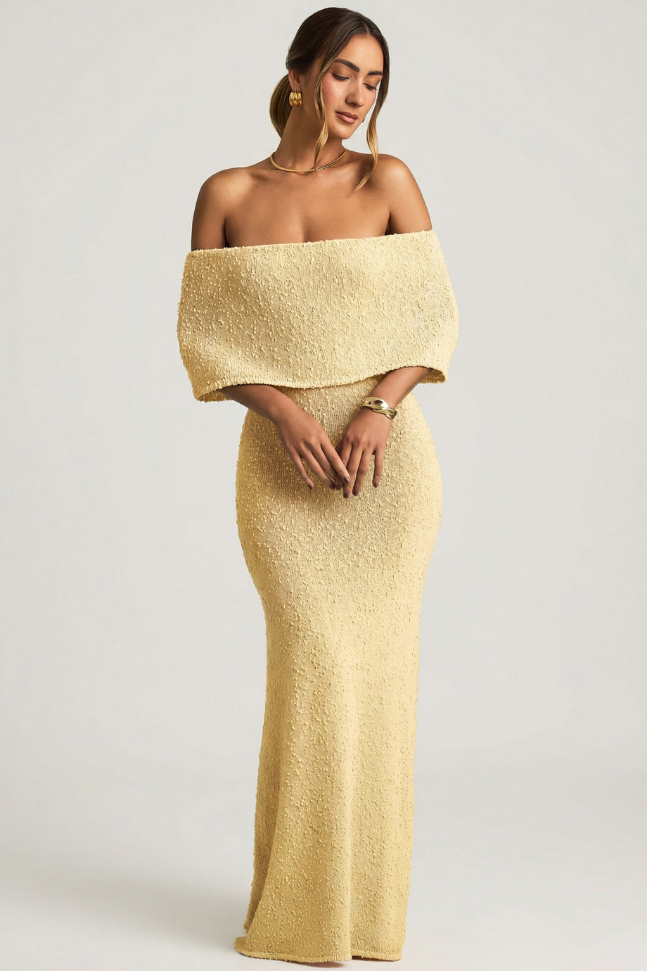 Oh Polly model Priscilla wearing the Naia Maxi Dress in Yellow Boucle Knit fabric perfect for spring weddings