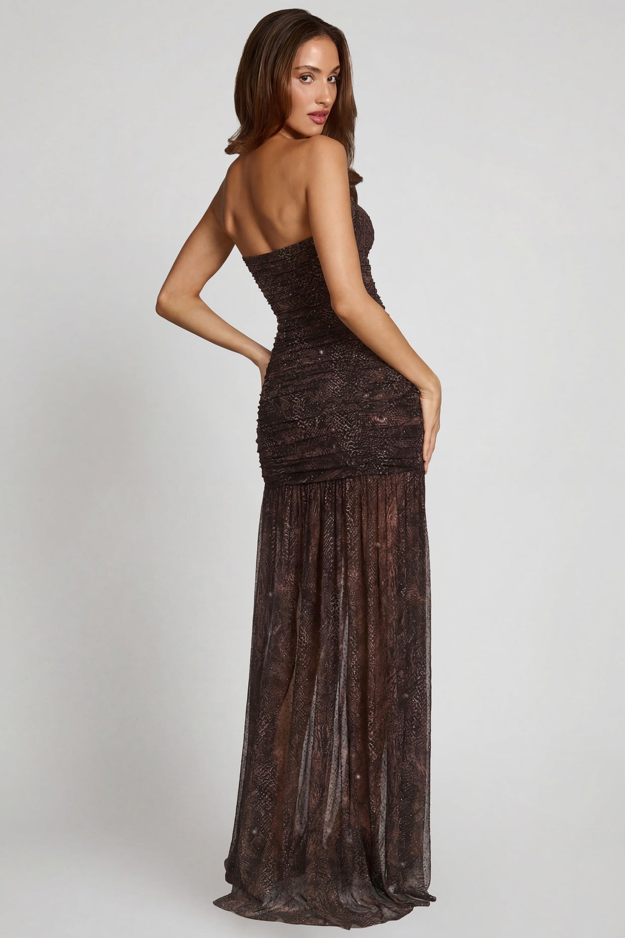 Oh Polly model Yasmin wearing the Ersilia Gown Length Dress in Snake Hotfix, Square Hotfix, Mesh fabric, perfect for a red carpet event