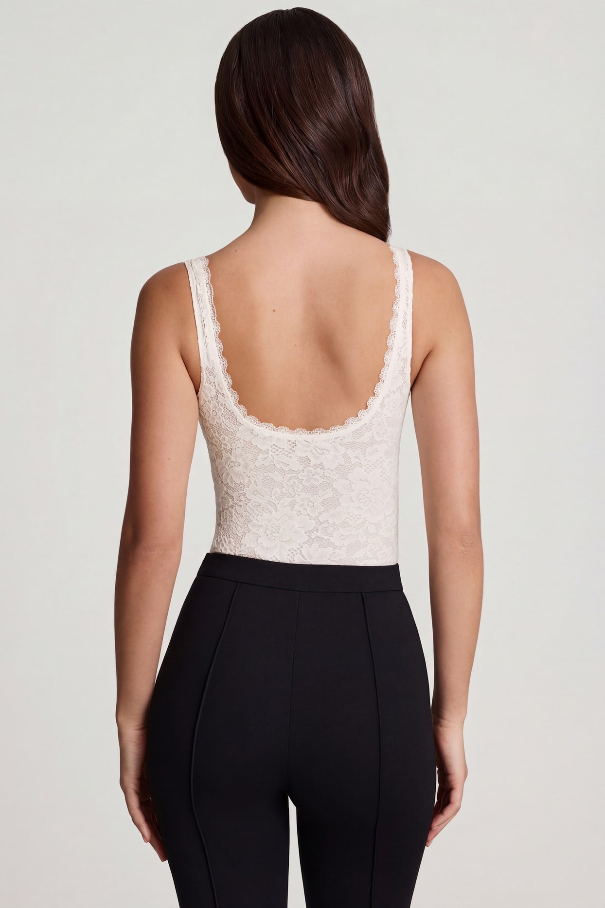 Oh Polly's Roberta wearing the Zayla Bodysuit in White Stretch Lace fabric perfect for summer date nights