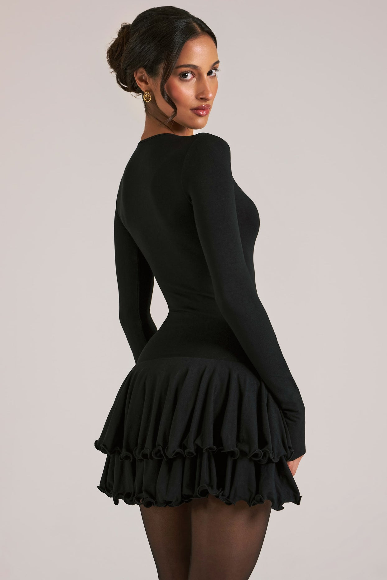 Oh Polly model Yasmin wearing the Cala Mini Dress in Black Soft Jersey fabric perfect for dinner dates