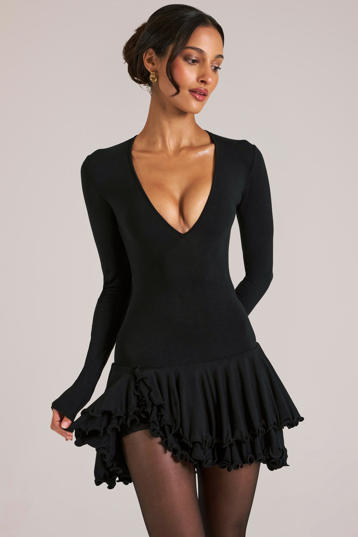 Oh Polly model Yasmin wearing the Cala Mini Dress in Black Soft Jersey fabric perfect for dinner dates