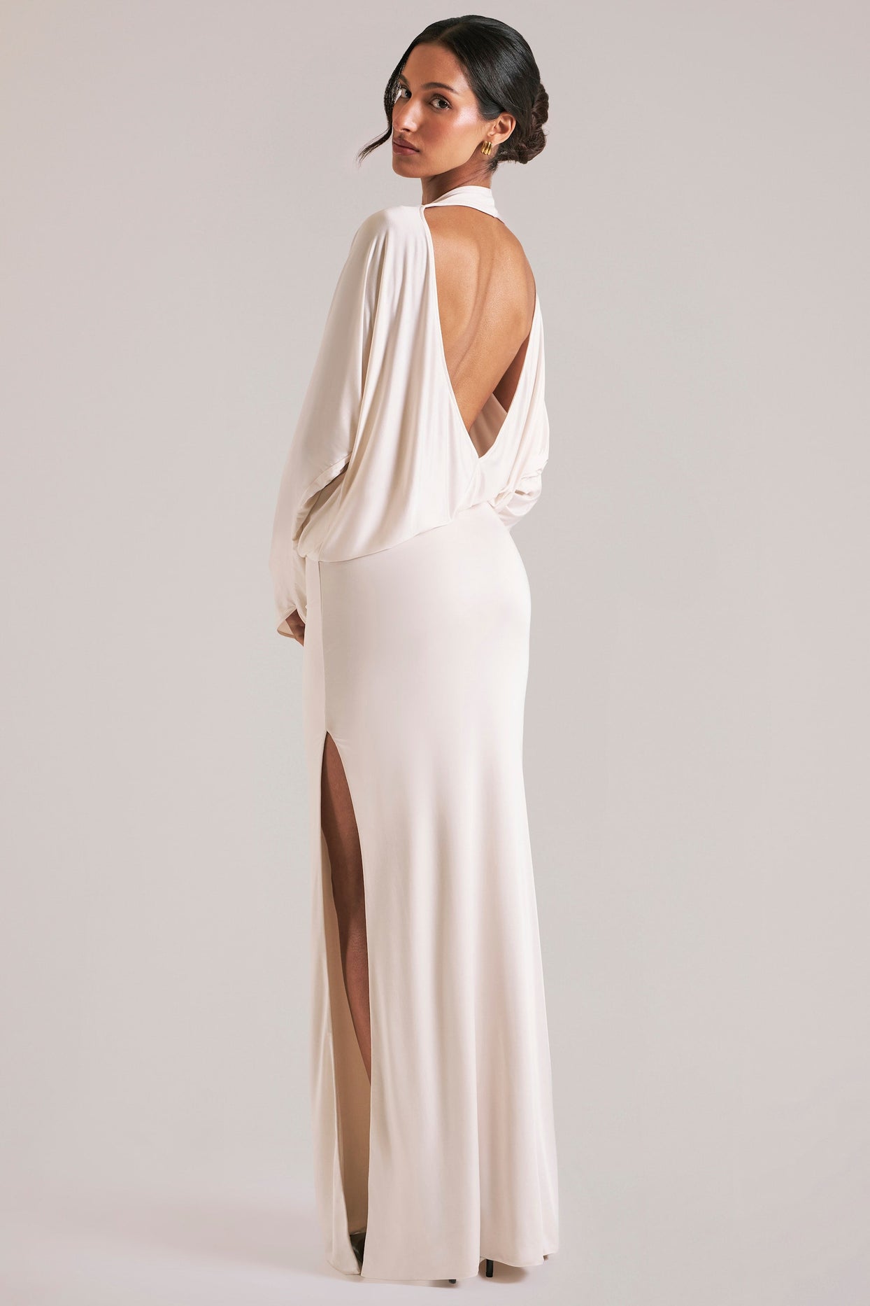 Oh Polly model Yasmin wearing the Lani Maxi Dress in Ivory Soft Jersey fabric perfect for rooftop cocktails