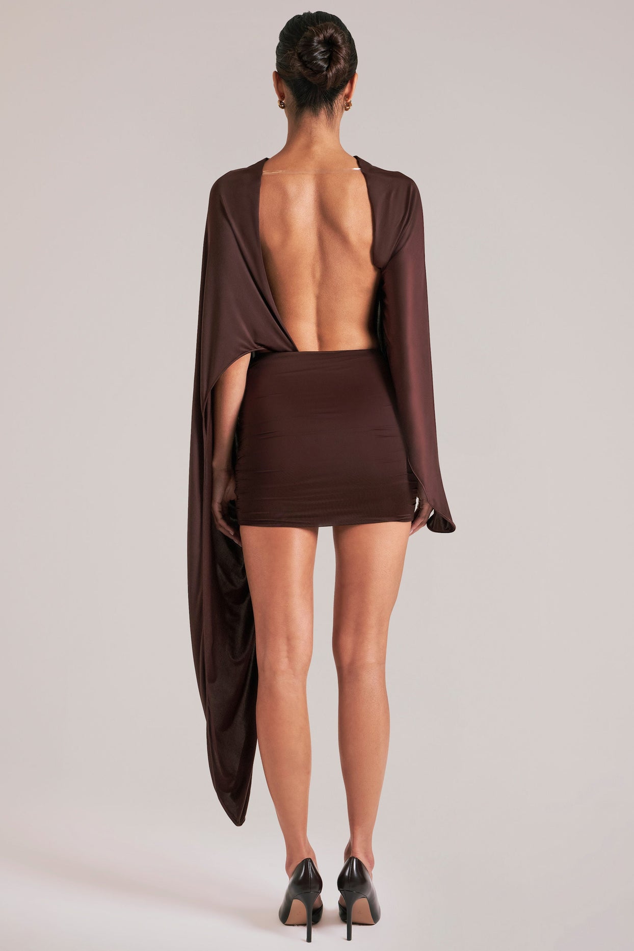 Oh Polly model Yasmin wearing the Lida Mini Dress in Chocolate Brown Satin fabric perfect for cocktail parties