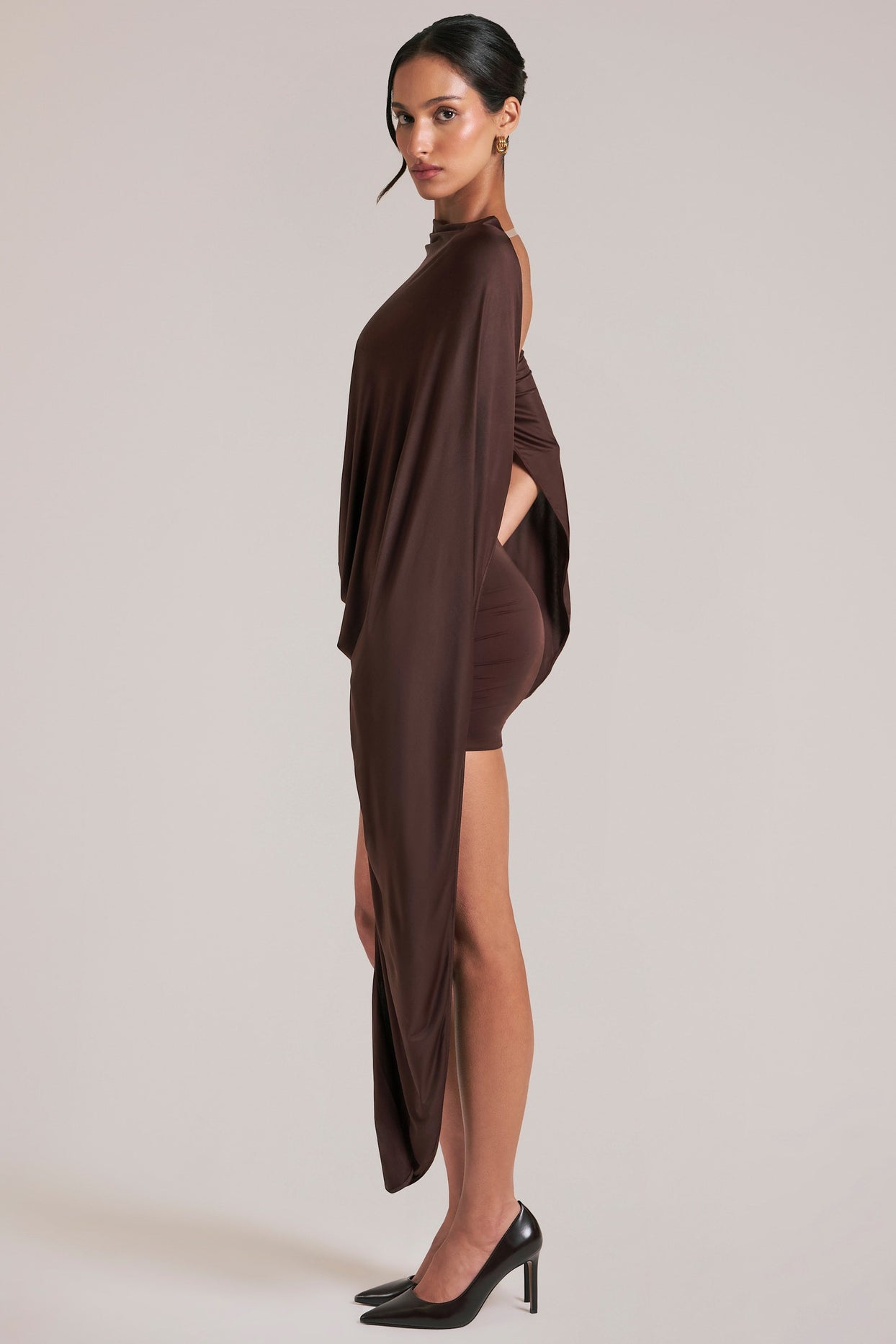 Oh Polly model Yasmin wearing the Lida Mini Dress in Chocolate Brown Satin fabric perfect for holiday dinners