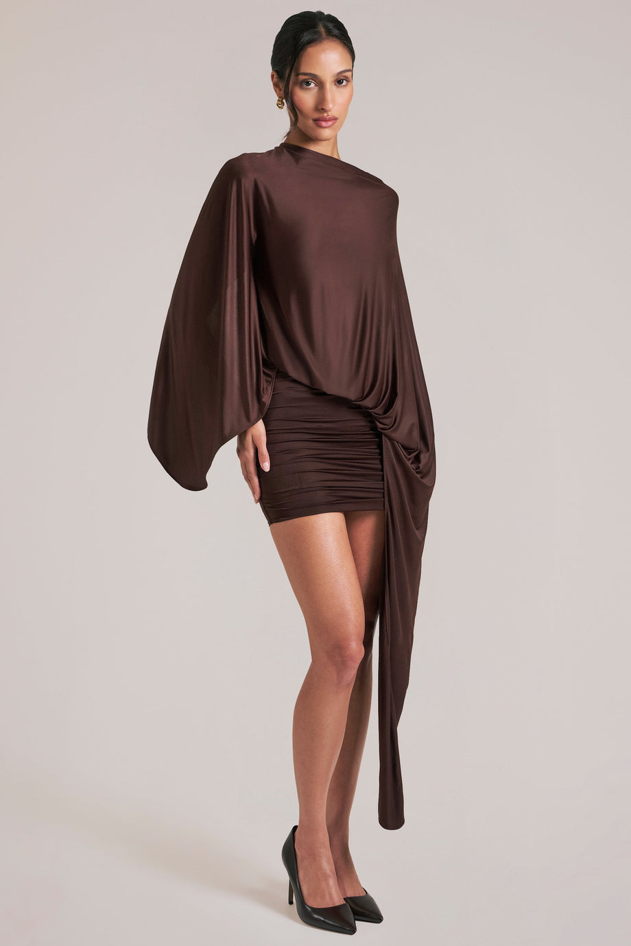 Oh Polly model Yasmin wearing the Lida Mini Dress in Chocolate Brown Satin fabric perfect for romantic dinners
