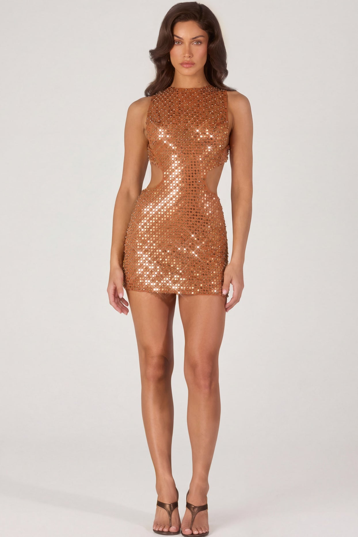 Oh Polly's Michelle Ivana wearing the Romilly Mini Dress in Bronze fabric perfect for a night out