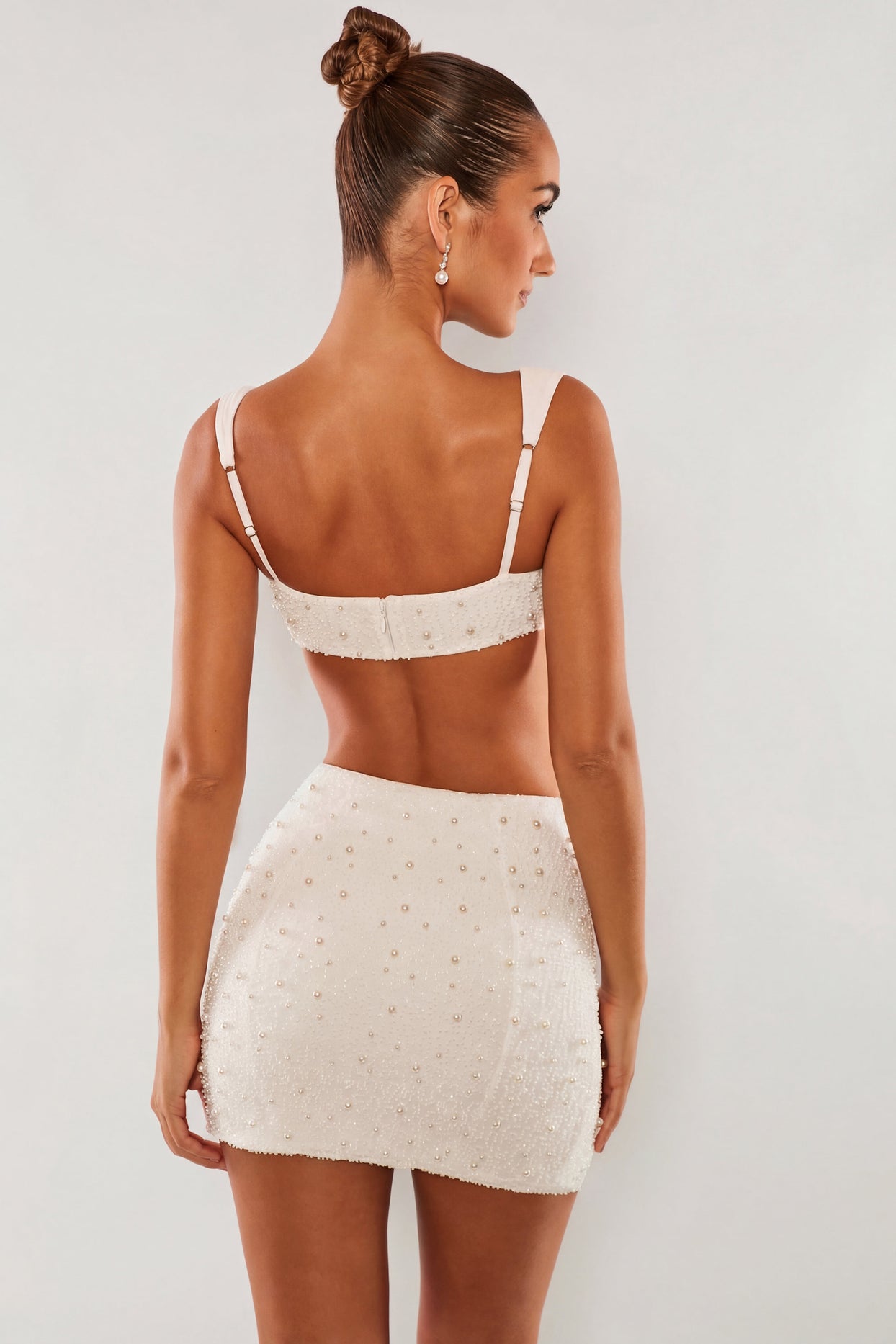 Oh Polly's Sierra Skye wearing the Belle Ile Mini Skirt in White Embellished fabric perfect for summer parties