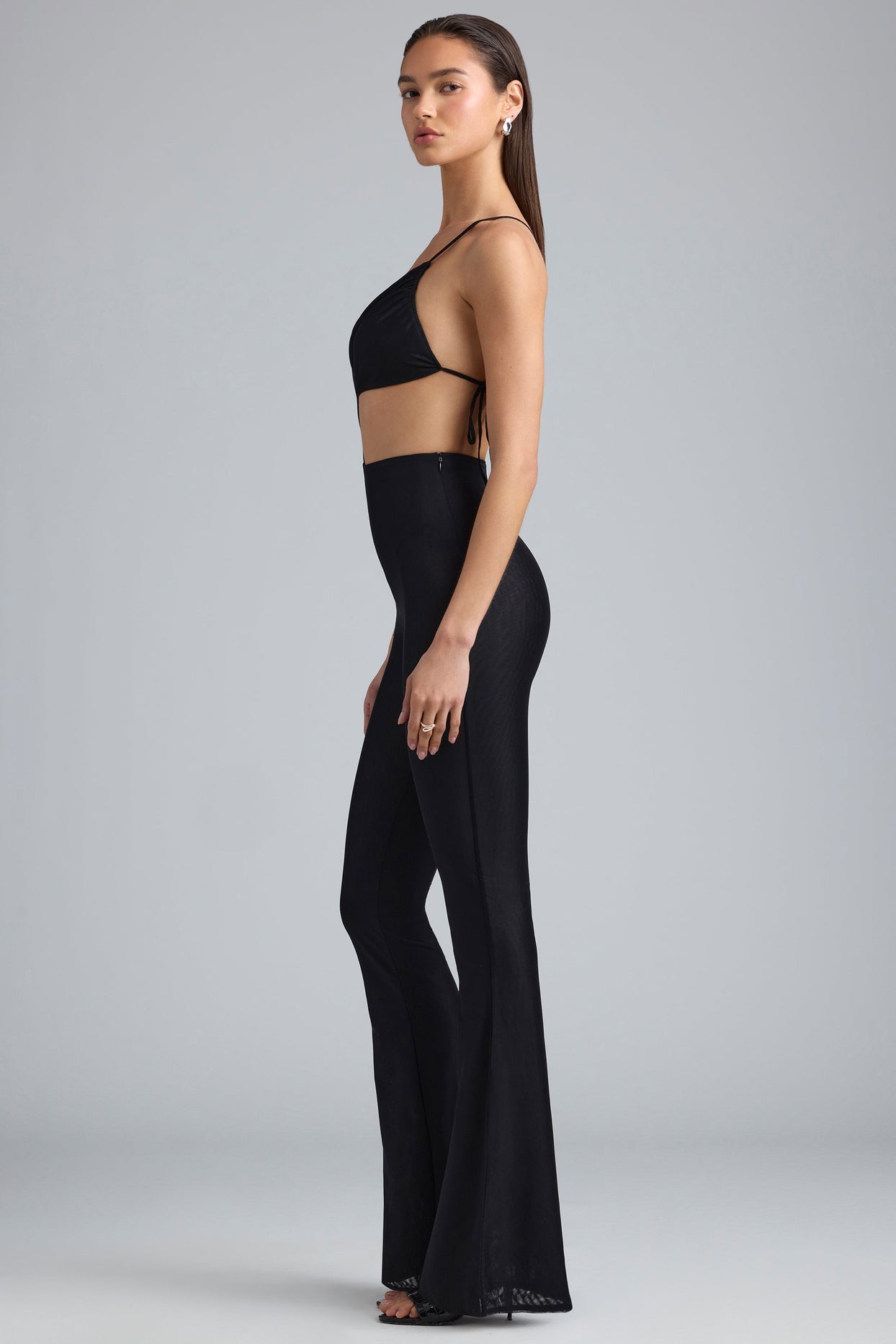 Amara Metallic Ruched Cut-Out Flared Jumpsuit in Black Oh Polly