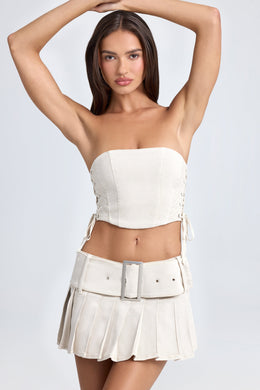 Belted Pleated Low-Rise Micro Mini Skirt in Ecru