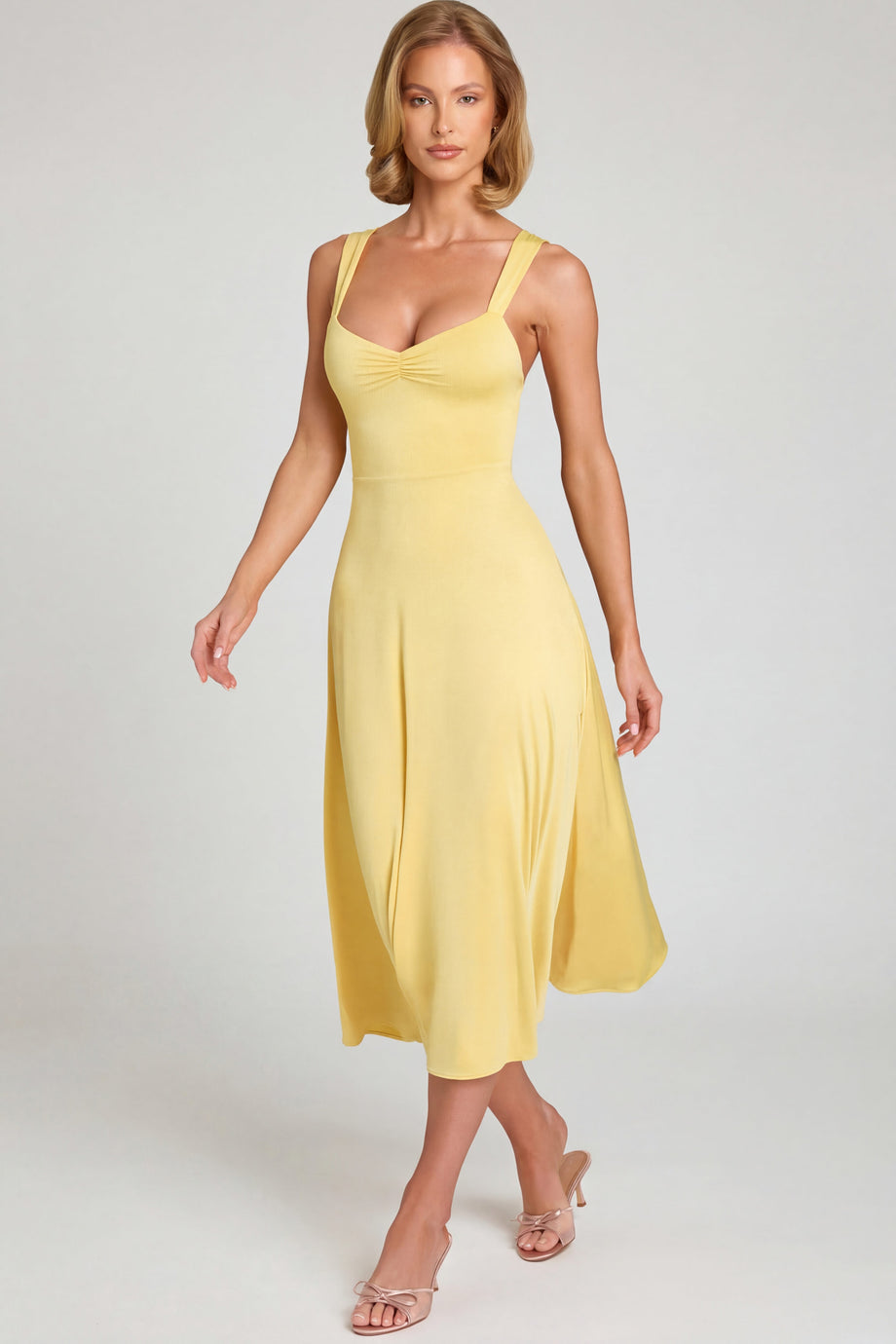 Oh Polly's Sienna wearing the Thandie Midaxi Dress in Pastel Yellow Slinky fabric perfect for wedding guest style