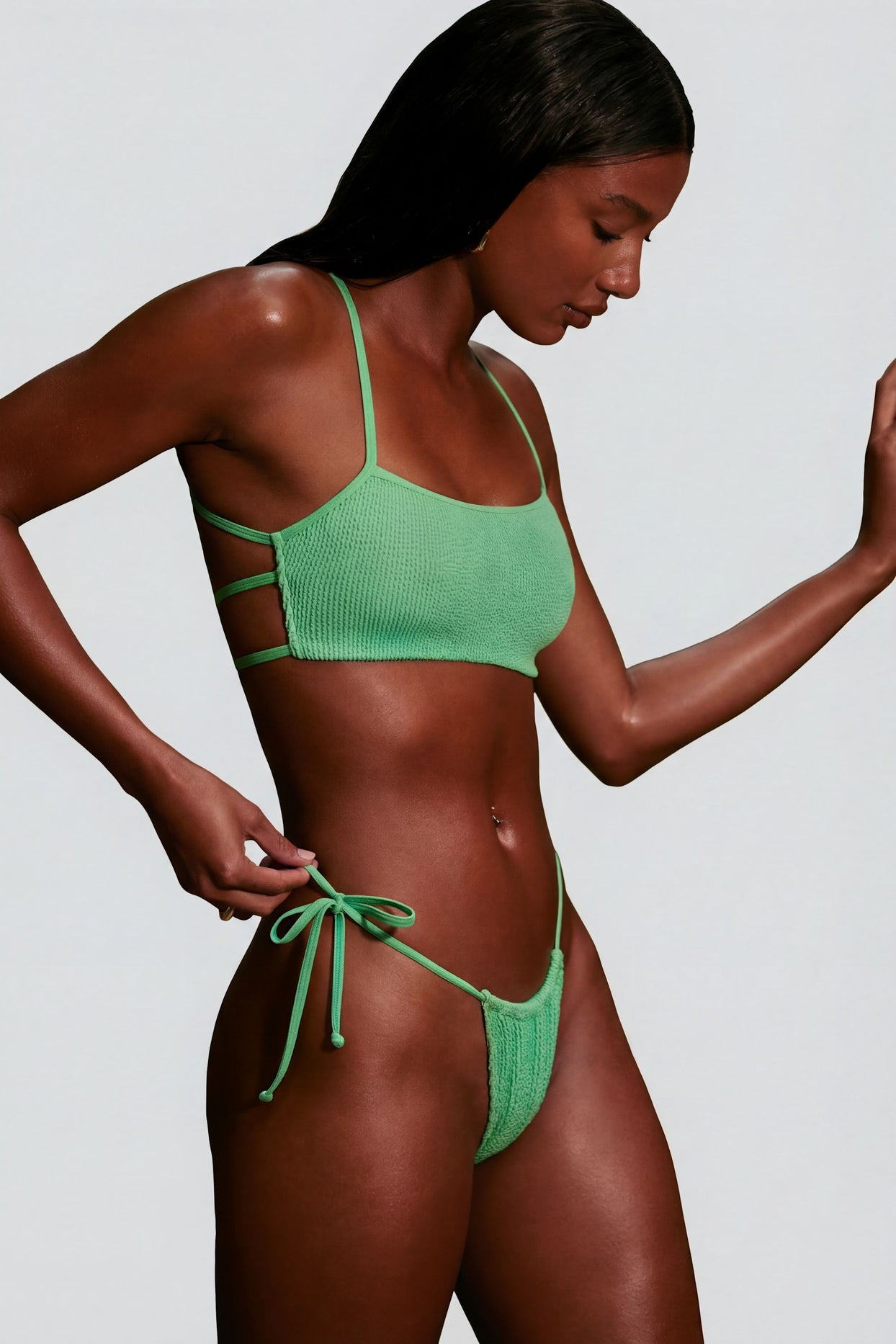 Oh Polly Swim's Kiele wearing the Seersucker Bikini Top in Seafoam Green fabric perfect for beach vacations