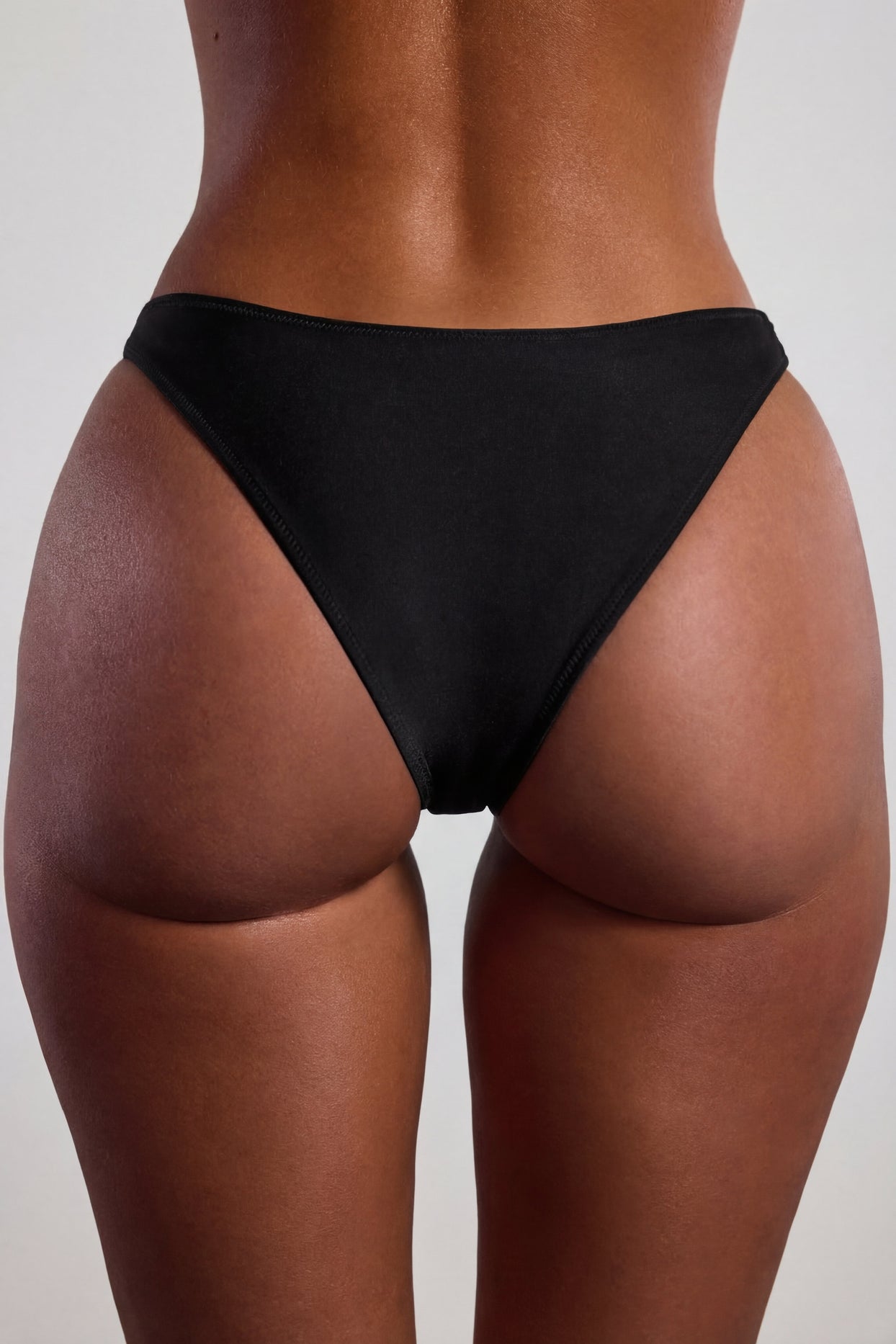 Oh Polly Swim's Sierra Skye wearing the Palau Bikini Bottoms in Black fabric perfect for beach vacations