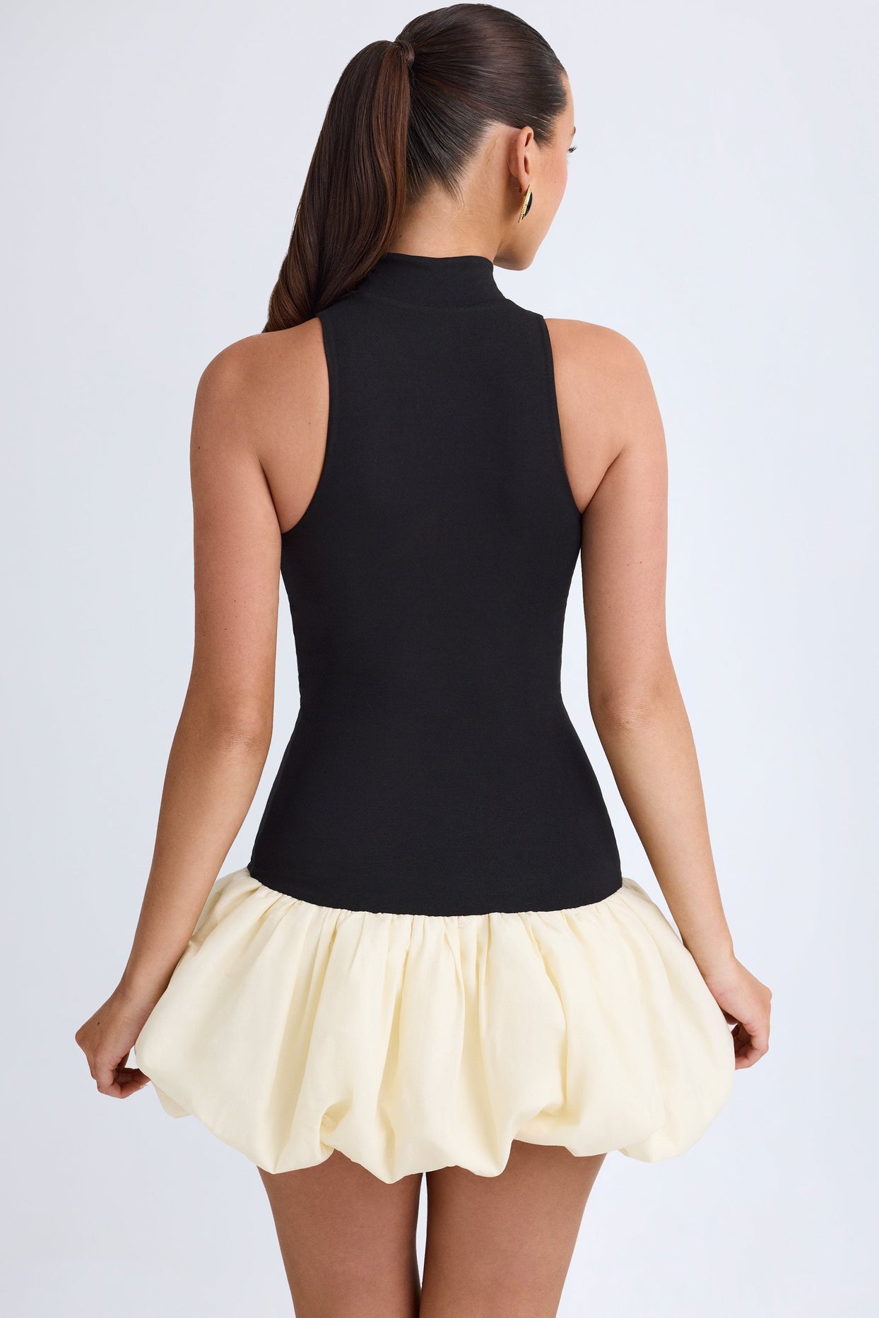 Nabila Turtleneck Drop-Waist Bubble Hem Mini Dress in Black