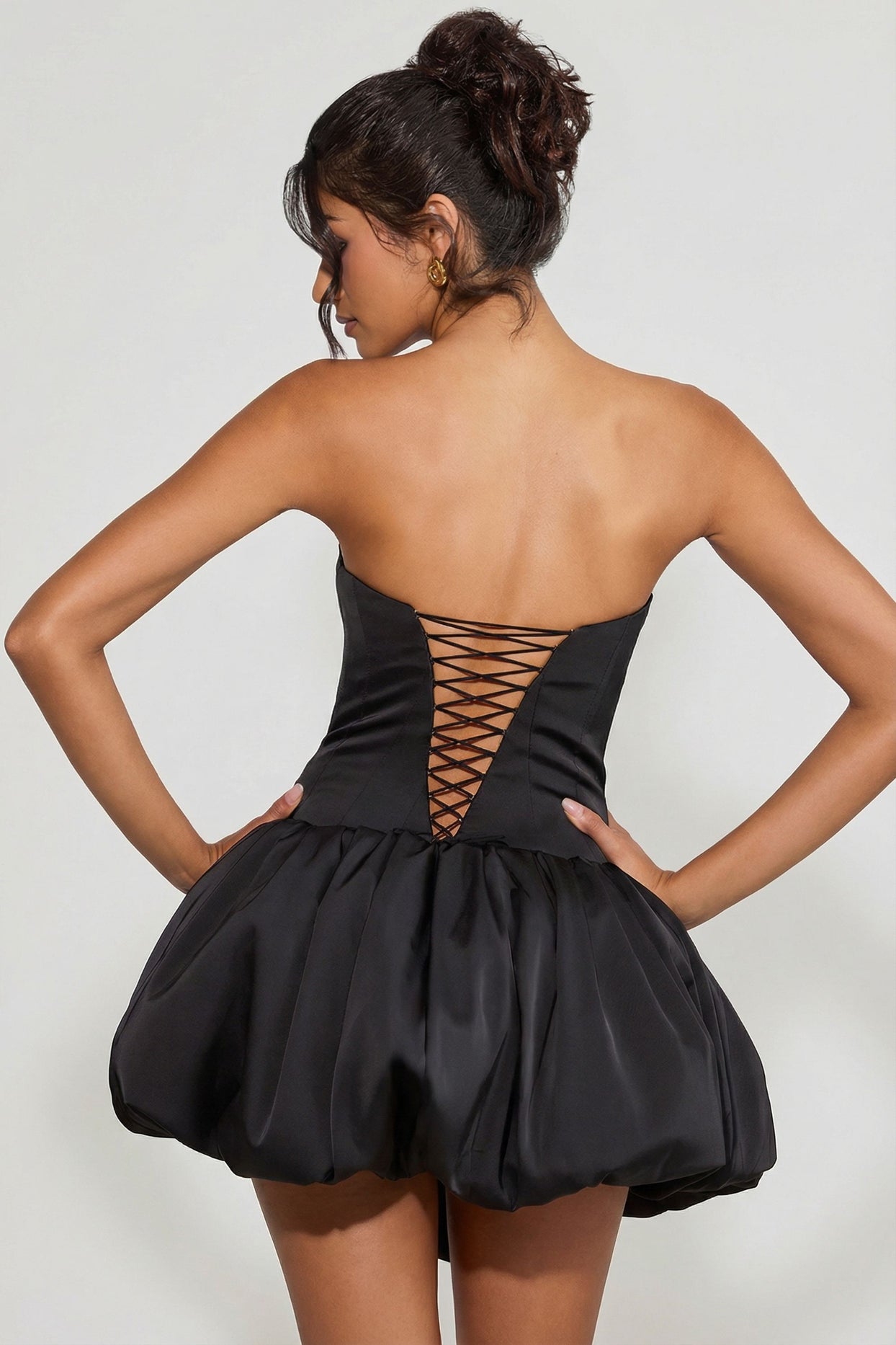 Oh Polly's Meeya wearing the Minerva Mini Dress in Black Satin fabric perfect for date night looks