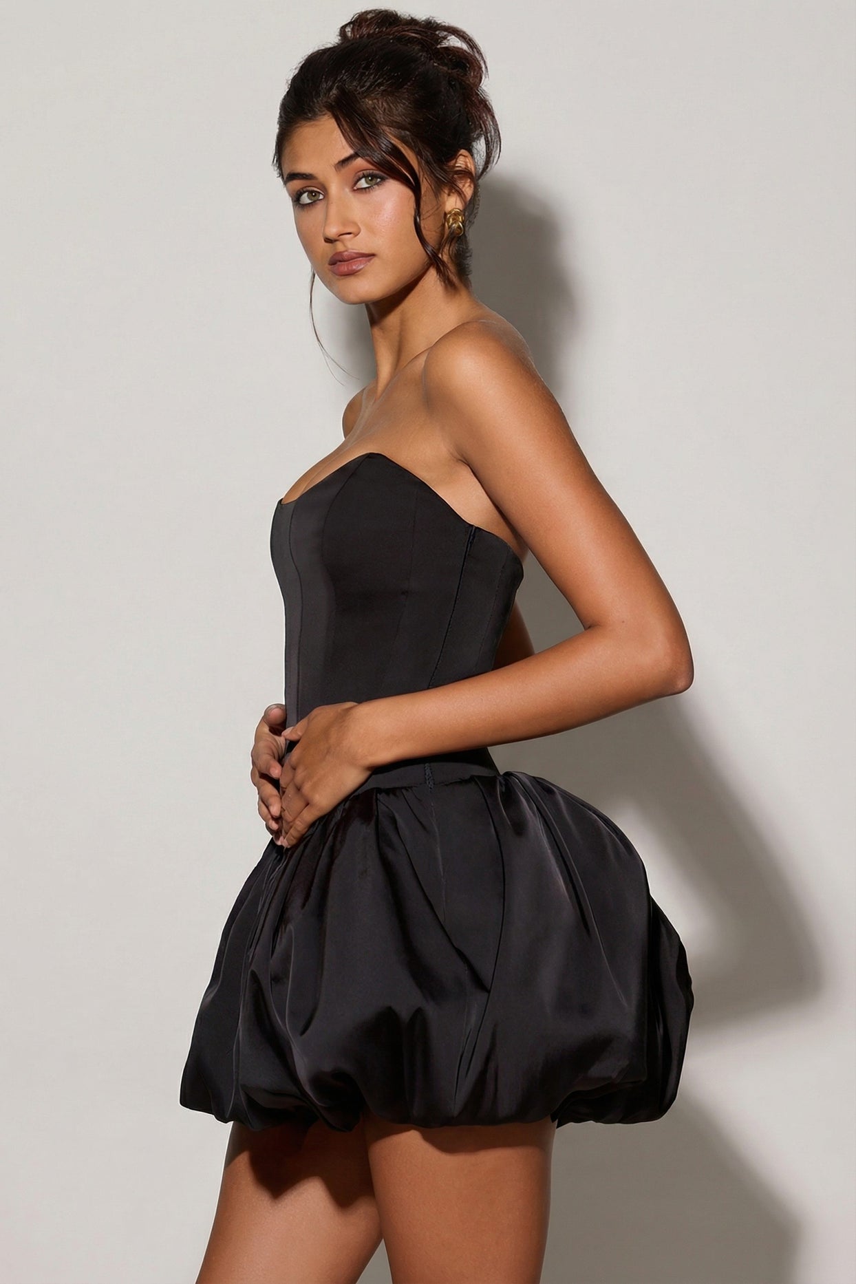 Oh Polly's Meeya wearing the Minerva Mini Dress in Black Satin fabric perfect for evening events