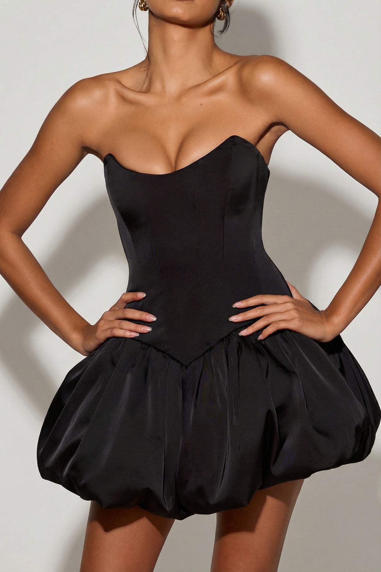 Oh Polly's Meeya wearing the Minerva Mini Dress in Black Satin fabric perfect for girls' night out